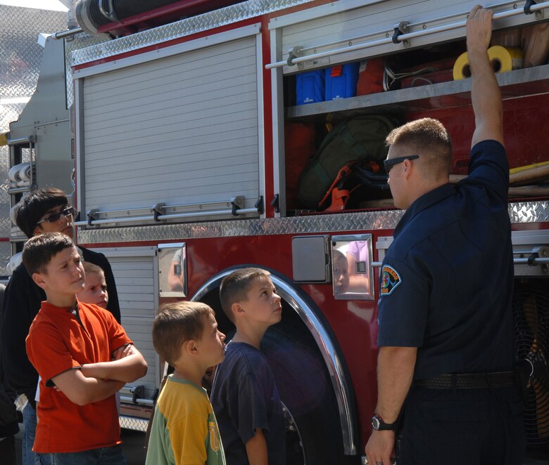 VANDENBERG AIR FORCE BASE, Calif. -- A member of the 30th Civil Engineer Squadron's fire and rescue emergency service gives Kids’ Fire Camp attendees a tour of a fire truck Aug. 15 at Fire Station 2  here. The camp is held annually for the children of Vandenberg to learn about fire safety and life in the fire department. (U.S. Air Force photo/Airman 1st Class Kerelin Molina)