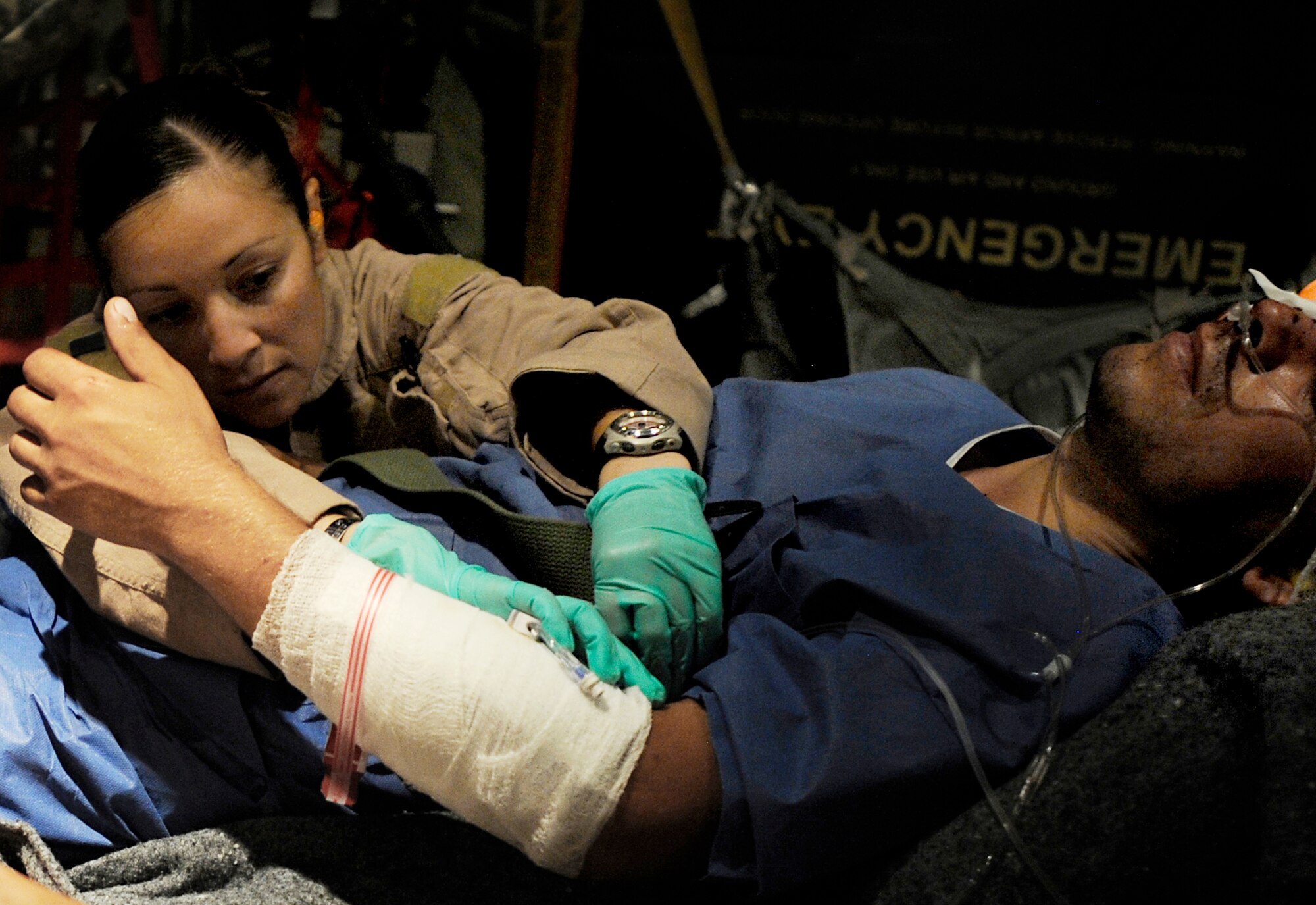 Senior Airman Maria Baird provides care to a patient during an aeromedical evacuation mission to transport patients July 19 from Kandahar Airfield, Afghanistan, to Bagram Airfield, Afghanistan. Airman Baird is an aeromedical technician assigned to the 451st Expeditionary Aeromedical Evacuation Flight. (U.S. Air Force photo/Staff Sgt. Shawn Weismiller) 