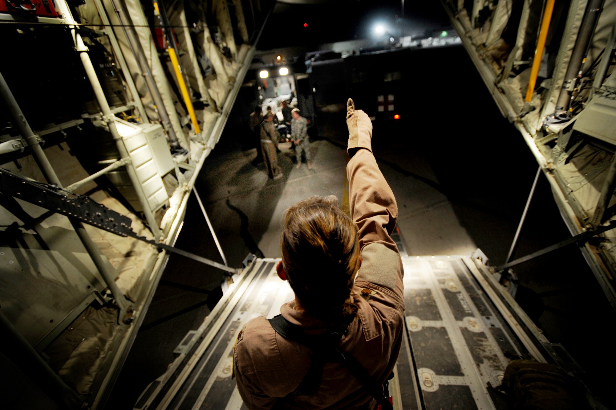 Maj. Missy Steckler directs the transport of patients from an ambulance to the cargo bay of a C-130J Super Hercules July 19 at Kandahar Airfield, Afghanistan. Major Steckler is a flight nurse with the 451st Expeditionary Aeromedical Evacuation Flight. (U.S. Air Force photo/Staff Sgt. Shawn Weismiller) 
