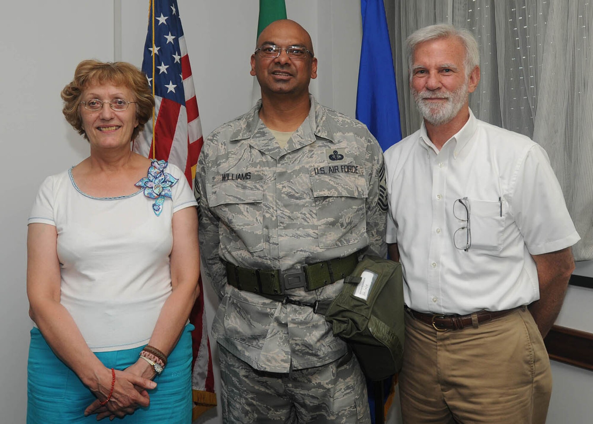 Chief Master Sgt. Laten Williams, 31st Fighter Wing command chief, congratulates Mariagrazia De Pol and Bill Nettelmann, both from the 31st Civil Engineer Squadron, for their selection as Aviano's Finest Aug. 20, 2009. Signorina De Pol was recognized in the Italian civilian category, while Mr. Nettelmann was recognized in the U.S. civilian category. Tech. Sgt. Jason Balolong, who is not pictured, was recognized in the military category. (U.S. Air Force photo/Airman 1st Class Ashley Wood)
