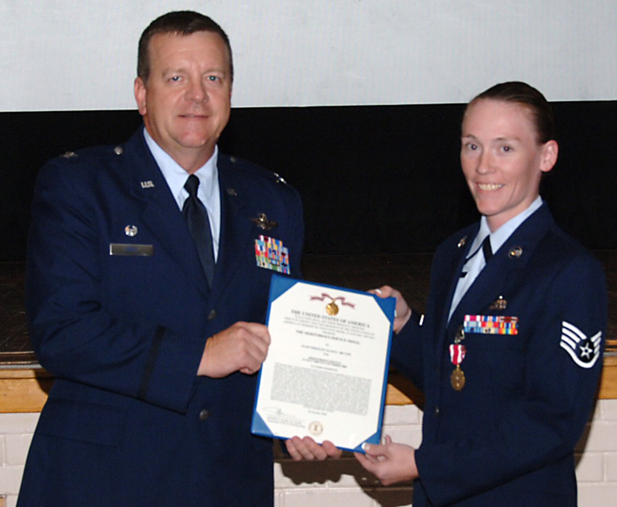 Col. Edsel "Archie" Frye Jr. presented Staff Sgt. Suann Becton a Meritorious Service Medal during a 931st Air Refueling Group commander's call in July 2009. Sergeant Becton is assigned to the 931st Aircraft Maintenance Squadron. Colonel Frye is the 931st ARG commander. (U.S. Air Force photo/Senior Airman Connor Burkhard)