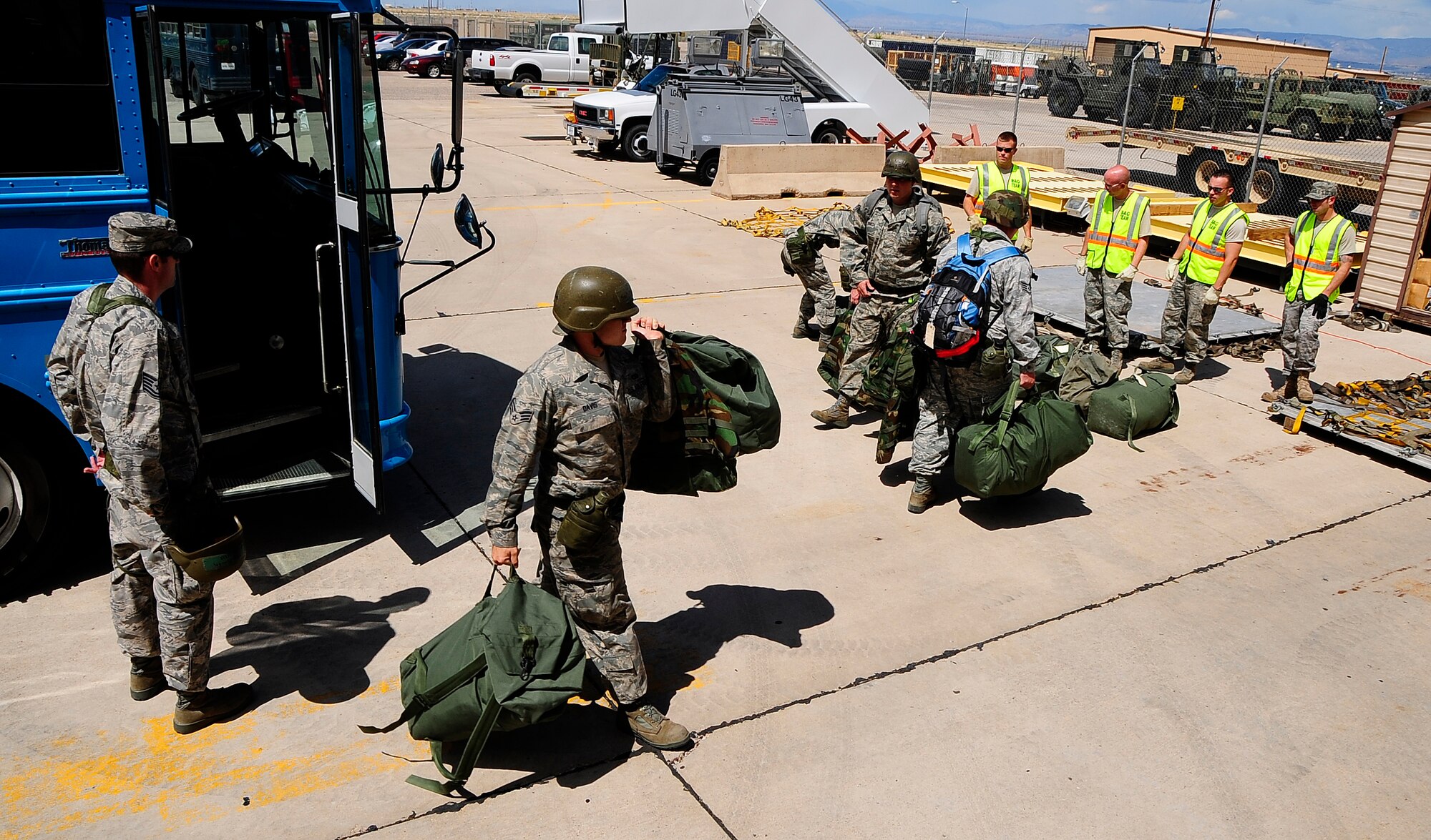 HOLLOMAN AIR FORCE BASE, N.M. -- Airmen from the 49th Aircraft Maintenance Squadron exit a bus to process through a deployment line while participating in a Phase I Operational Readiness Exercise here Aug. 18. (U.S. Air Force photo by Tech. Sgt. Chris Flahive)
