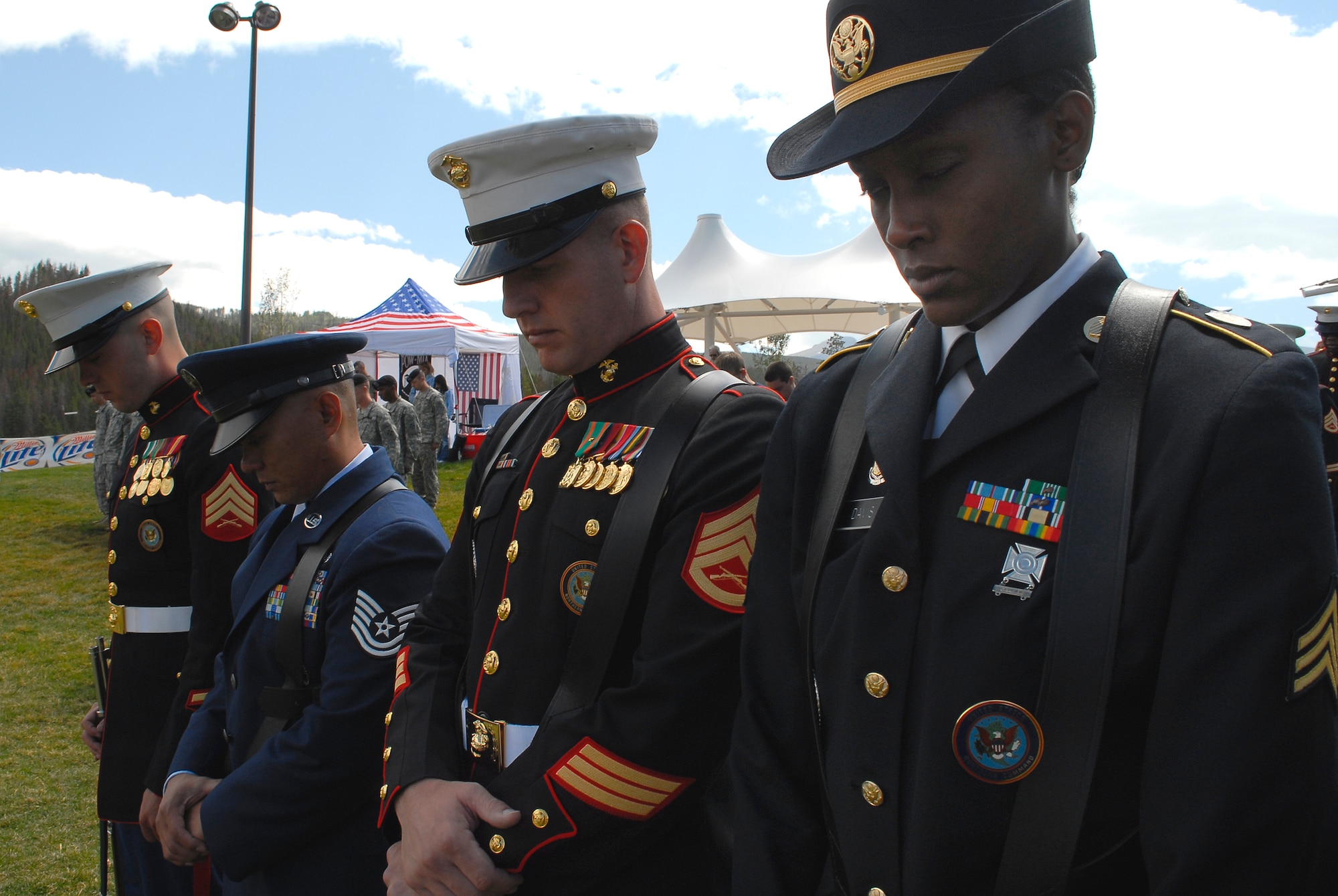 NORAD U.S. Northern Command Joint Color Guard members bow their heads during a moment of silence for military members left behind during the Salute to American Veterans Rally and Festival.  The rally is held annually in Winter Park, Colo. (U.S. Air Force photo by Tech. Sgt. J. LaVoie)