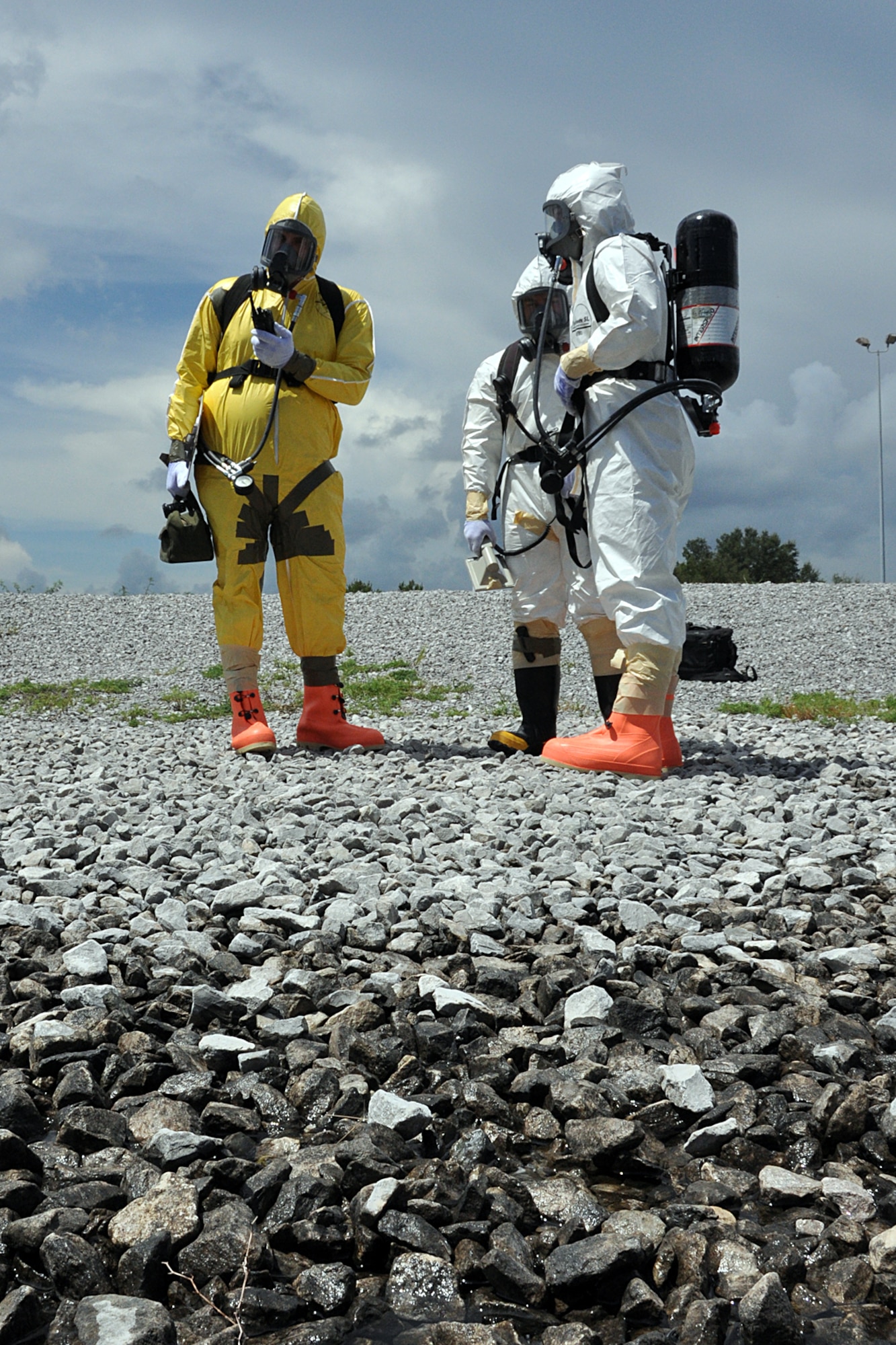 EGLIN AIR FORCE BASE, Fla. – (left to right) Staff Sgt Garrett Sheppard , Airman 1st Class Nick Graham and Airman 1st Class James Allen, 96th Civil Engineer Group Explosive Ordinance Disposal, check readings at a simulated crash site during a nuclear accident response exercise here, Aug. 18. The NARE put Eglin’s readiness to the test after a simulated C-17 Globemaster declared an in-flight-emergency and subsequently crashed with 10 people and a special weapon on board. These exercises maintain readiness for Eglin’s emergency responders, follow-on forces and maintain qualifications of command and control personnel. During the exercise, agencies had the opportunity to work with other Eglin units they don’t train with regularly. (U.S. Air Force photo/ Airman Anthony Jennings)