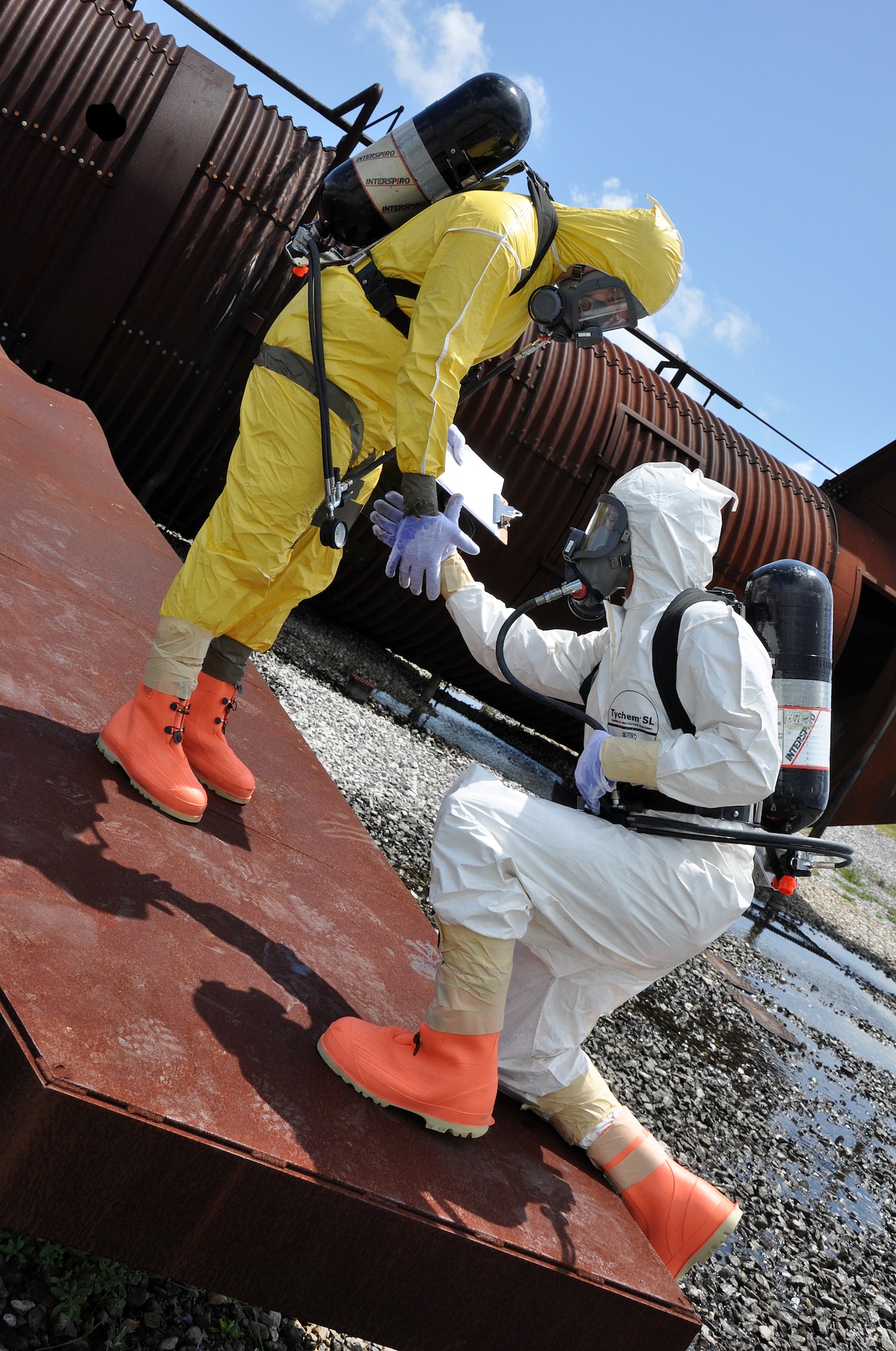 EGLIN AIR FORCE BASE, Fla. – Staff Sgt. Garrett Sheppard lends a helping hand to Airman 1st Class James Allen during nuclear accident response exercise here, Aug. 18. The NARE put Eglin’s readiness to the test after a simulated C-17 Globemaster declared an in-flight-emergency and subsequently crashed with 10 people and a special weapon on board. These exercises maintain readiness for Eglin’s emergency responders, follow-on forces and maintain qualifications of command and control personnel. During the exercise, agencies had the opportunity to work with other Eglin units they don’t train with regularly. (U.S. Air Force photo/ Airman Anthony Jennings)