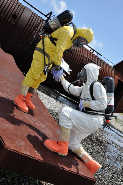 EGLIN AIR FORCE BASE, Fla. – Staff Sgt. Garrett Sheppard lends a helping hand to Airman 1st Class James Allen during nuclear accident response exercise here, Aug. 18. The NARE put Eglin’s readiness to the test after a simulated C-17 Globemaster declared an in-flight-emergency and subsequently crashed with 10 people and a special weapon on board. These exercises maintain readiness for Eglin’s emergency responders, follow-on forces and maintain qualifications of command and control personnel. During the exercise, agencies had the opportunity to work with other Eglin units they don’t train with regularly. (U.S. Air Force photo/ Airman Anthony Jennings)