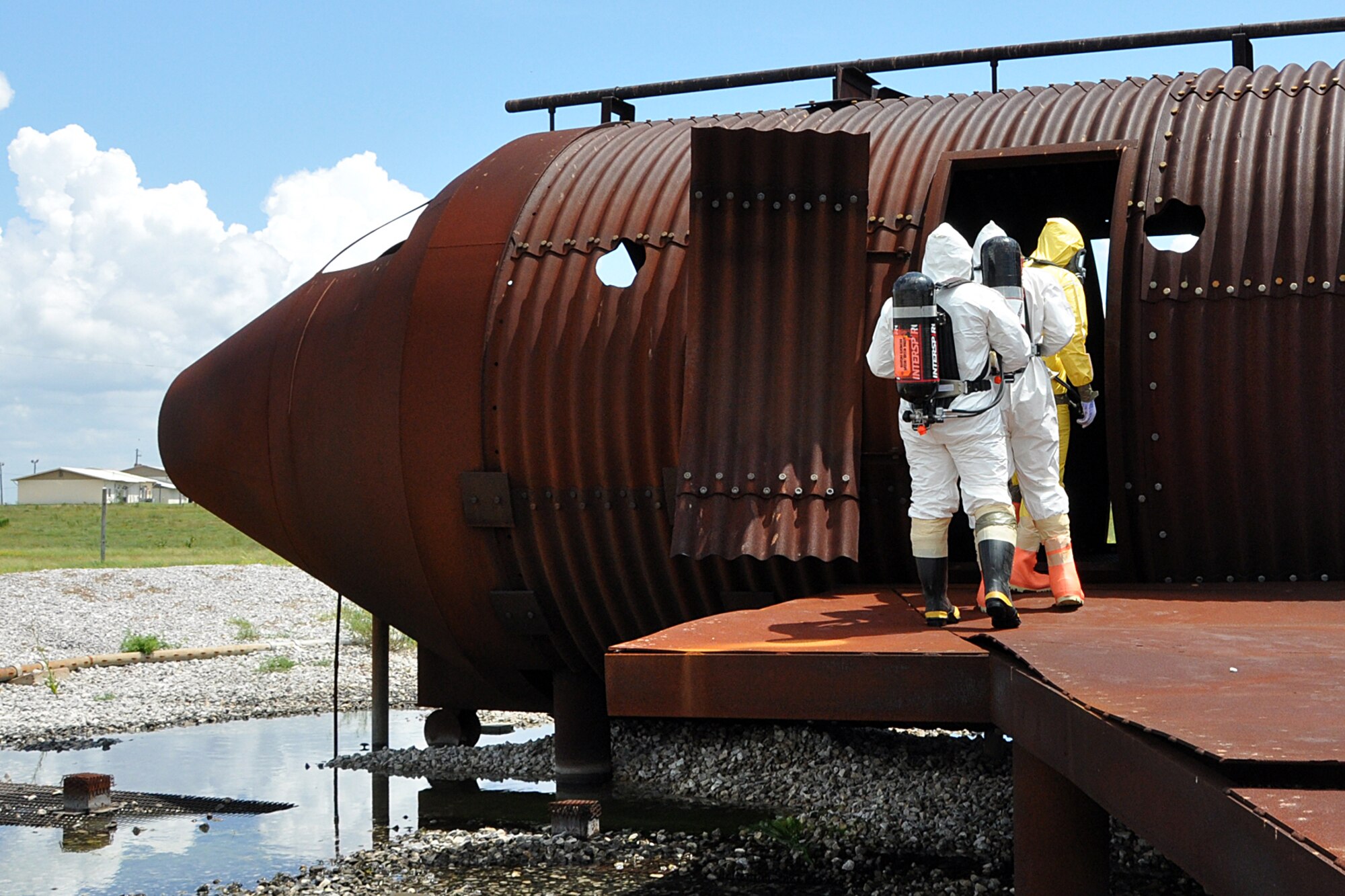 EGLIN AIR FORCE BASE, Fla. -- Explosive Ordinance Disposal technicians enter a simulated crash site during a nuclear accident response exercise here, Aug. 18. The NARE put Eglin’s readiness to the test after a simulated C-17 Globemaster declared an in-flight-emergency and subsequently crashed with 10 people and a special weapon on board. These exercises maintain readiness for Eglin’s emergency responders, follow-on forces and maintain qualifications of command and control personnel. During the exercise, agencies had the opportunity to work with other Eglin units they don’t train with regularly. (U.S. Air Force photo/ Airman Anthony Jennings)