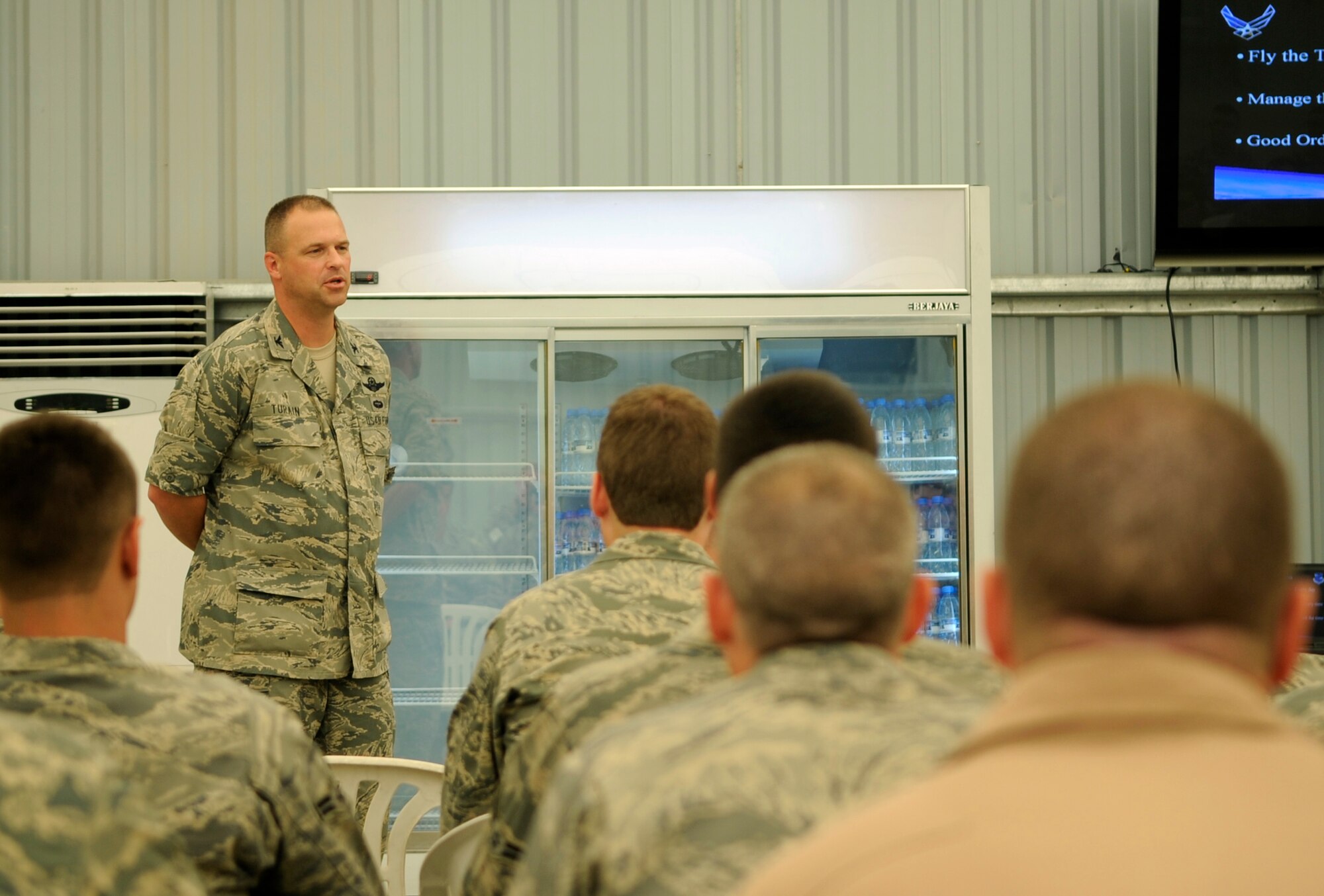 SOUTHWEST ASIA – Col. Kip Turain, 380th Air Expeditionary Wing vice commander, welcomes Airmen to the 380th AEW during Warrior Welcome Aug. 18. The Airmen receive briefings from commanders and base agencies that acquaint members with the 380th AEW. Colonel Turain hails from Perrysburg, Ohio. (U.S. Air Force photo/Senior Airman Stephen Linch)