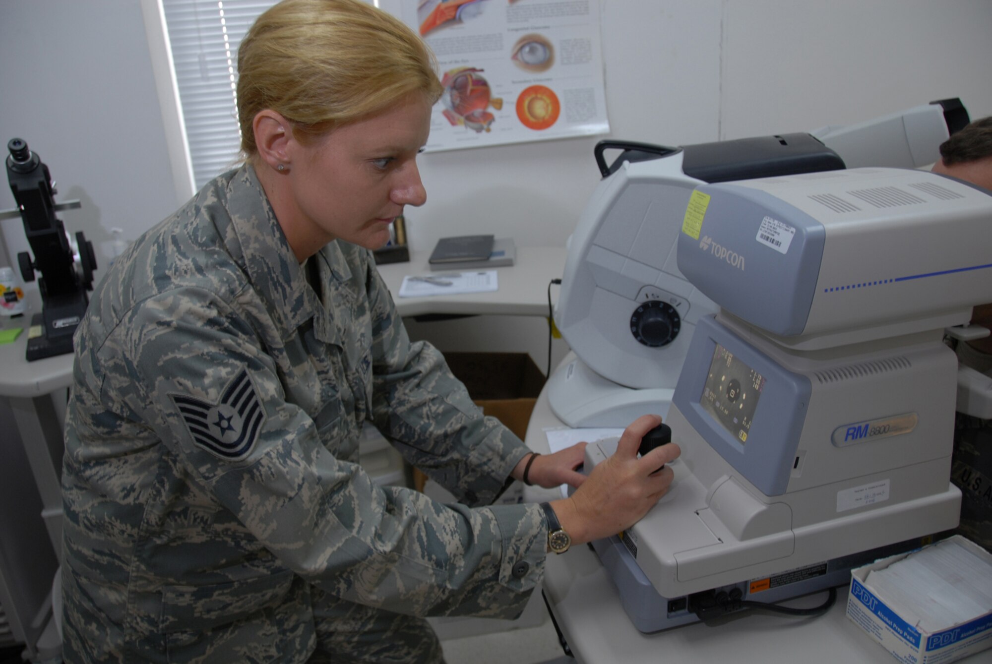 Tech. Sgt. Sarah Fry, 379th Expeditionary Medical Group ophthalmic craftsman, reads the shape of a patient?s cornea using an automated refractor here, Aug. 20. The optometry clinic provides routine exams and emergency eye care services to deployed servicemembers at this undisclosed location in Southwest Asia. Sergeant Fry is a native of Cheyenne, Wyo., and is deployed from the Wyoming Air National Guard in support of Operations Iraqi and Enduring Freedom.  (U.S. Air Force Photo/Tech. Sgt. Jason W. Edwards)