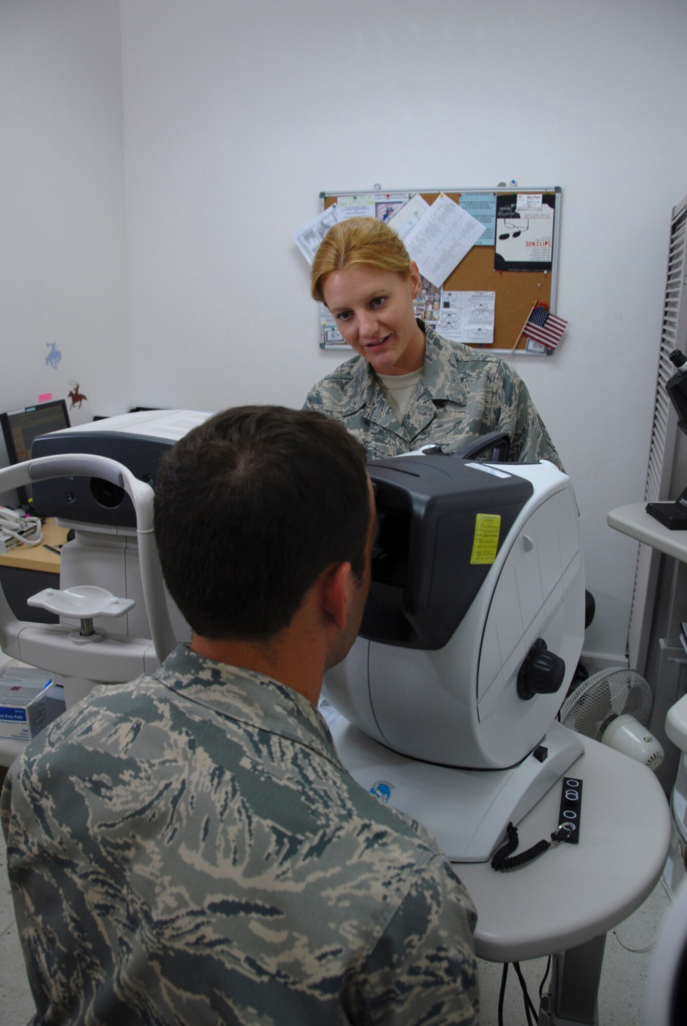 Tech. Sgt. Sarah Fry, 379th Expeditionary Medical Group ophthalmic technician, administers a visual acuity test to a patient, Aug. 20. The optometry clinic provides routine exams and emergency eye care services to deployed servicemembers at this undisclosed location in Southwest Asia. Sergeant Fry is a native of Cheyenne, Wyo., and is deployed from the Wyoming Air National Guard in support of Operations Iraqi and Enduring Freedom.  (U.S. Air Force Photo/Tech. Sgt. Jason W. Edwards)