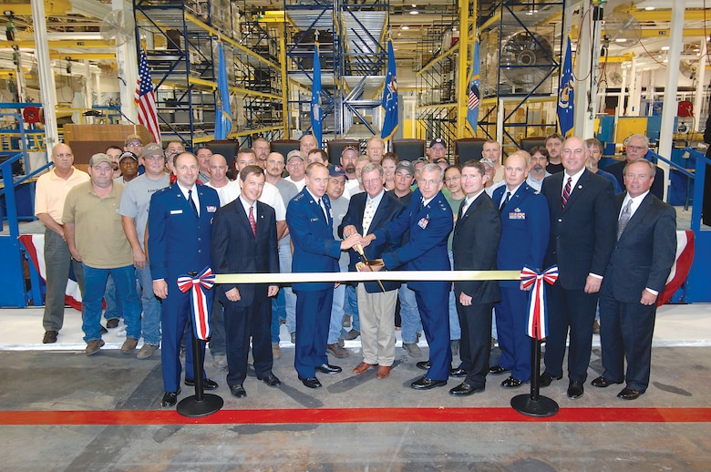 Air Force and Oklahoma government officials gather Aug. 17 to attend an open house in celebration of the Tinker Aerospace Complex's largest facility, Bldg. 9001. From left are, Brig. Gen. Bruce Litchfield, 76th Maintenance Wing commander; Scott Meacham, Oklahoma state treasurer; Gen. Donald Hoffman, commander of Air Force Materiel Command; Sen. James Inhofe, R-Okla.; Maj. Gen. David Gillett, Oklahoma City Air Logistics Center commander; James Schmidt, Local 916 union president; Col. Kelly Larson, commander of the Defense Logistics Agency, Oklahoma City; Ray Vaughn, Oklahoma County commissioner and David Thompson, of the Greater Oklahoma City Chamber of Commerce. The event took place in the 545th Propulsion Maintenance Squadron's TF33 turbo fan engine maintenance shop, where workers moved after renovation of Bldg. 9001. In September 2008, the Air Force entered into a low-cost, long-term lease, with Oklahoma County for use of the former General Motors facility. (Air Force photo/Dave Faytinger)