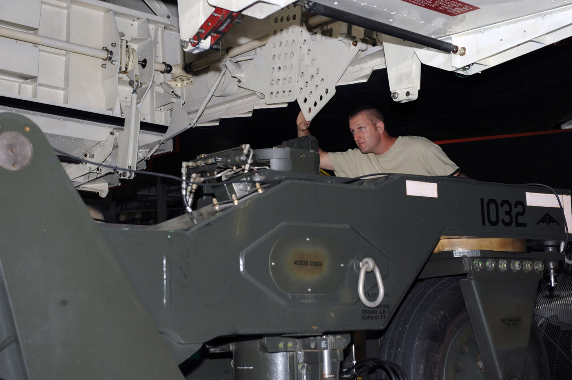 WHITEMAN AIR FORCE BASE, Mo. – Tech. Sgt. Ryan Graney, Loading Standardization Crew member, assists in guiding a weapons trailer under the Weapons Load Trainer Aug. 14. Loading and unloading the WLT, as well as an actual B-2, requires a four-man team of certified weapons system loaders. (U.S. Air Force photo/Senior Airman Jason Huddleston)
