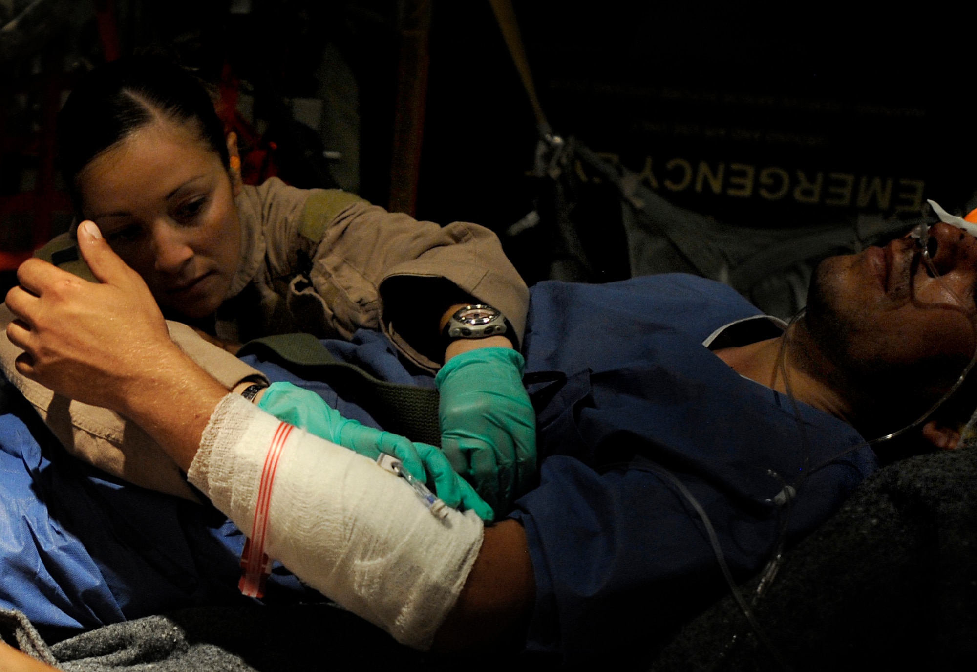 U.S. Air Force Senior Airman Maria Baird, an aeromedical technician assigned to the 451st Expeditionary Aeromedical Evacuation Flight, provides care to a patient during an Aeromedical Evacuation mission to transport patients from Kandahar Air Field to Bagram Air Base July 19, Kandahar Air Field, Afghanistan. (U.S. Air Force Photo by Staff Sgt. Shawn Weismiller)(RELEASED)