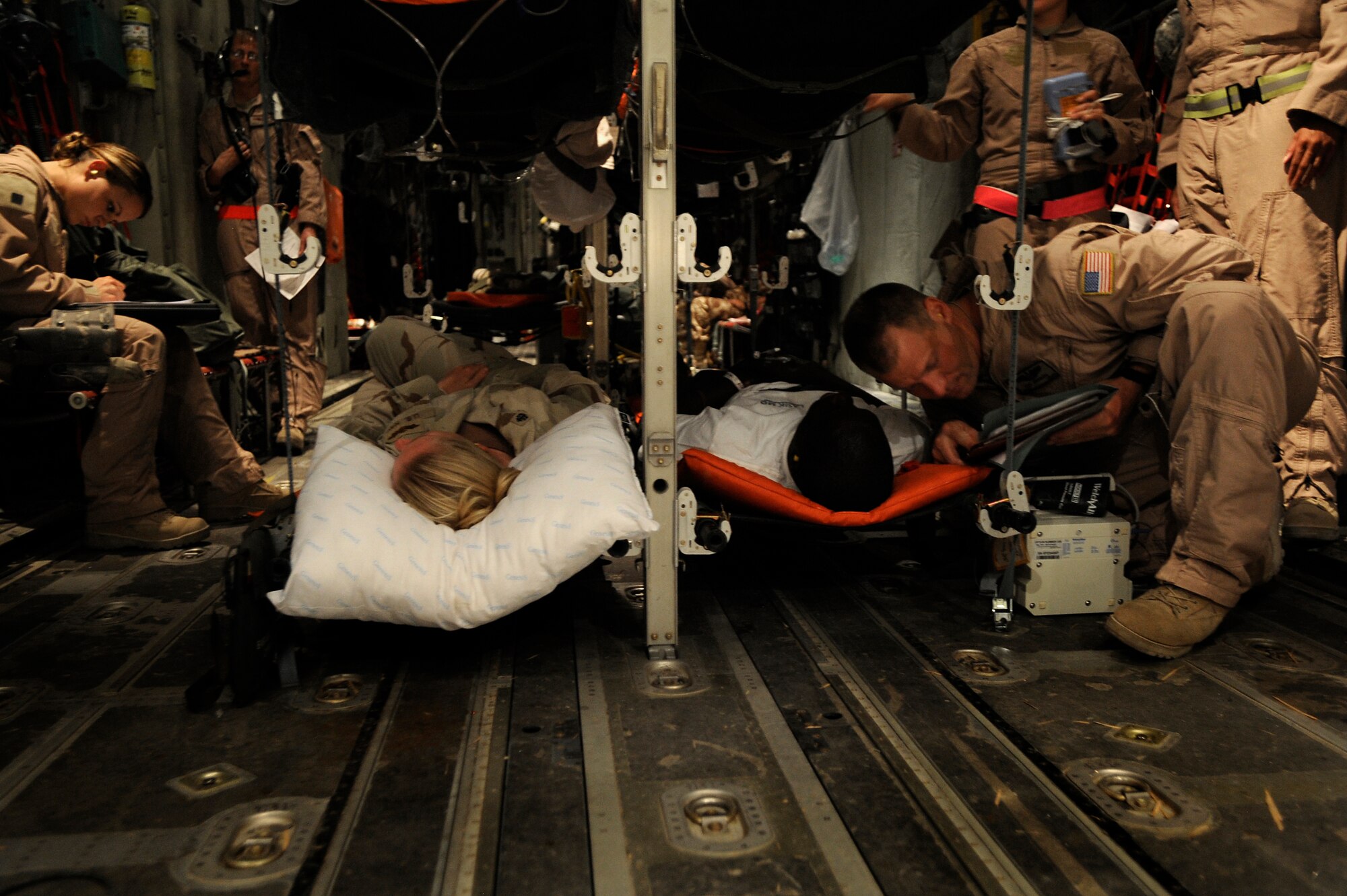 U.S. Air Force Master Sgt. Zachary Johnson, 451st Expeditionary Aeromedical Evacuation Flight, aeromedical technician, cares for a patient during an Aeromedical Evacuation mission to transport patients from Kandahar Air Field to Bagram Air Base July 19, Kandahar Air Field, Afghanistan. (U.S. Air Force Photo by Staff Sgt. Shawn Weismiller)(RELEASED)