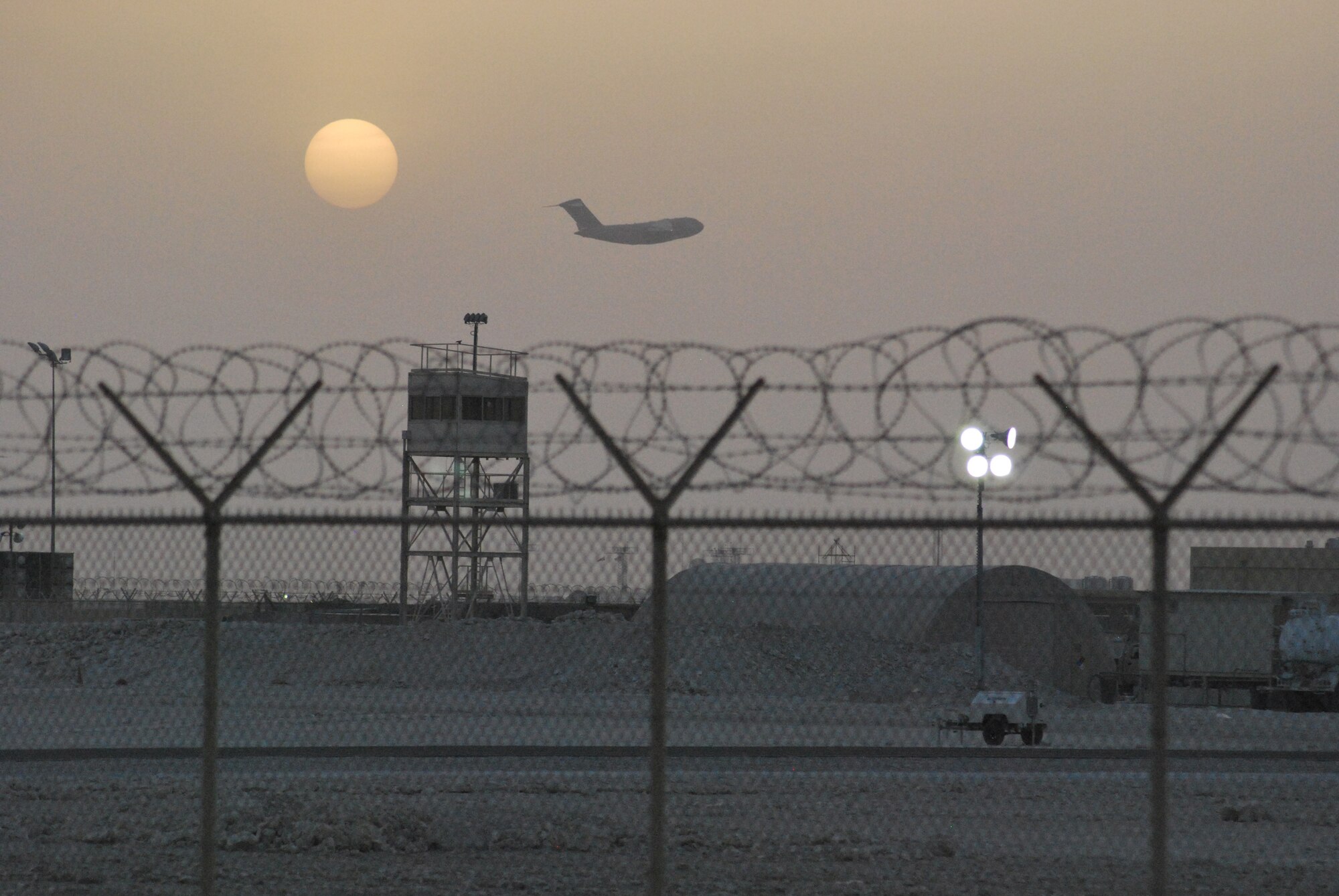 SOUTHWEST ASIA - As the sun sets a new day is only beginning for the crew of this U.S. Air Force Globemaster III departing from a base in Southwest Asia in support of Operation ENDURING FREEDOM.  (U.S. Air Force photo by Lt. Col. Reid Christopherson)