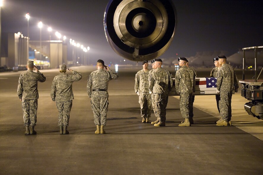 A U.S. Army carry team transfers the remains of Army Cpl. Nicholas R. Roush, of Middleville, Mich., at Dover Air Force Base, Del., August 17. Specialist Roush was assigned to the 1st Psychological Battalion, 4th Psychological Operations Group (Airborne), Fort Bragg, N.C. (U.S. Air Force photo/Tom Randle)