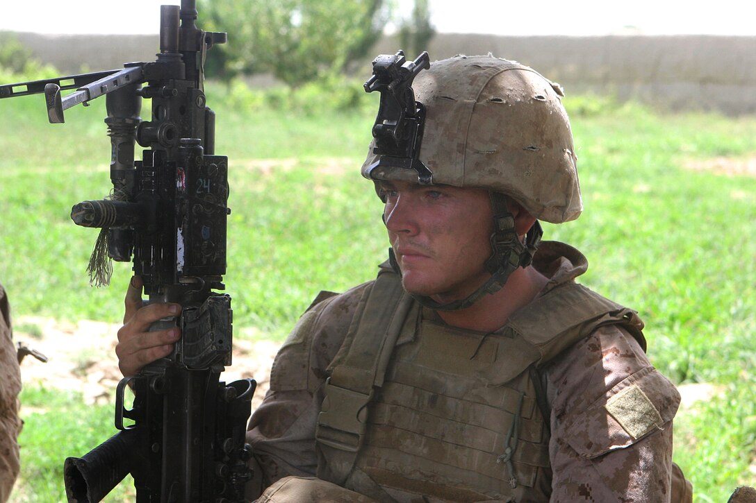 U.S. Marine Corps Lance Cpl. Timothy Daughtry takes a quick rest after a six-hour firefight with insurgents in the Garmsir district in Helmand province, Afghanistan, Aug. 13, 2009. Daughtry is a saw gunner assigned to Echo Company, 2nd Battalion, 8th Marine Regiment.