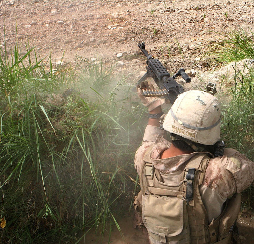 U.S. Marine Corps Cpl. A.J. Manglona fires his M240G medium machinegun at insurgents in Mian Poshteh, Garmsir district in Helmand province, Afghanistan, after drawing fire Aug. 15, 2009. Manglona is a machine gunner assigned to Echo Company, 2nd Battalion, 8th Marine Regiment.