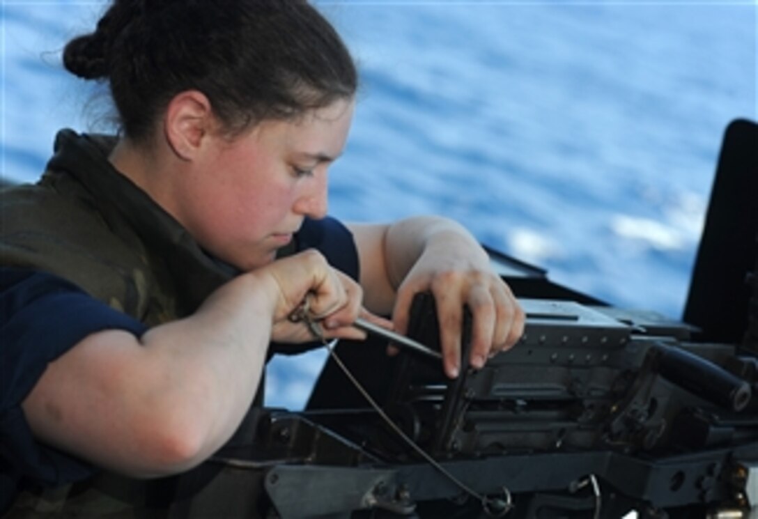 U.S. Navy Petty Officer 3rd Class Nicole Blair repairs a jammed .50-caliber machine gun during a security training exercise aboard the aircraft carrier USS Harry S. Truman (CVN 75) underway in the Atlantic Ocean on Aug. 8, 2009.  The ship is conducting carrier qualifications.  