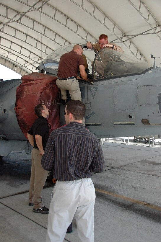 Officer Candidate School candidates line up to question Capt. Rick Carmean, Marine Attack Squadron 311 pilot, about the cockpit of an AV-8B Harrier outside the squadron’s hangar at the Marine Corps Air Station in Yuma, Ariz., Aug. 20, 2009. VMA-311 pilots taught 17 potential future aviators about squadron and Harrier history.