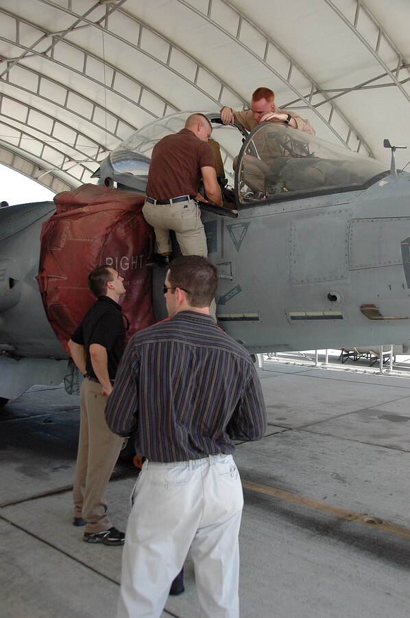 Officer Candidate School candidates line up to question Capt. Rick Carmean, Marine Attack Squadron 311 pilot, about the cockpit of an AV-8B Harrier outside the squadron’s hangar at the Marine Corps Air Station in Yuma, Ariz., Aug. 20, 2009. VMA-311 pilots taught 17 potential future aviators about squadron and Harrier history.
