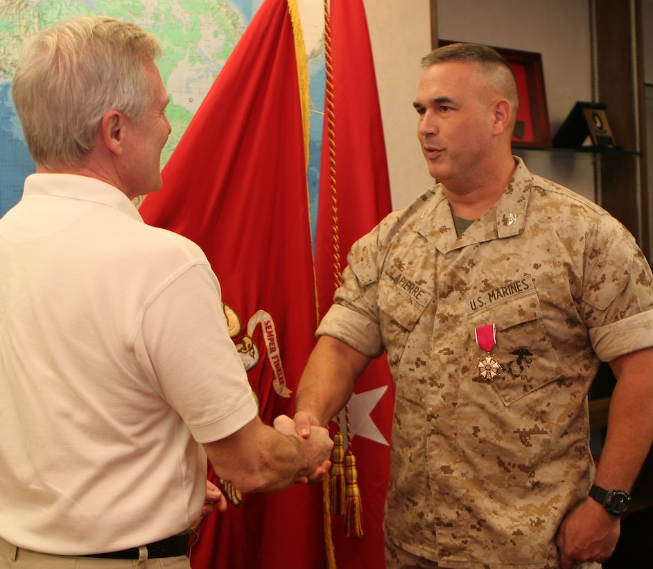 Secretary of the Navy, the Honorable Mr. Ray Mabus (left) is the first to congratulate Colonel Martin E. LaPierre, officer-in-charge, U.S. Marine Corps Forces, Pacific (fwd) Guam, for receiving the Legion of Merit Medal at Camp Smith, August 21. LaPierre received the award for protecting Marine Corps interests in the projected realignment of Okinawa based forces to Guam. (Official U.S. Marine Corps photo taken by Sgt Jose E. Castellonlopez)(Released)