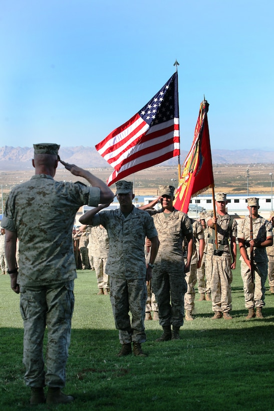 Maj. Gen. Richard Mills, the commanding general of 1st Marine Division, returns a salute from Lt. Col. John Reed, the commanding offer of 2nd Battalion, 7th Marine Regiment, and Lance Cpl. Richard Weinmaster, a Squad Automatic Weapon gunner with 3rd Platoon, Company E, 2nd Battalion, 7th Marine Regiment, at the beginning of the ceremony in which Mills awarded Weinmaster the Navy Cross Thursday at Lance Cpl. Torrey Gray Field.