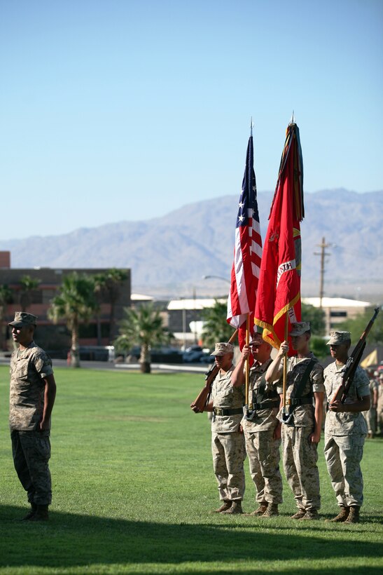 Lance Cpl. Richard S. Weinmaster, a Squad Automatic Weapon gunner with 3rd Platoon, Company E, 2nd Battalion, 7th Marine Regiment, stands in front of the color guard moments before being awarded the highest award for valor given by the department of the Navy, the Navy Cross, and a meritorious promotion to corporal in a ceremony Thursday at Lance Cpl. Torrey L. Gray Field.