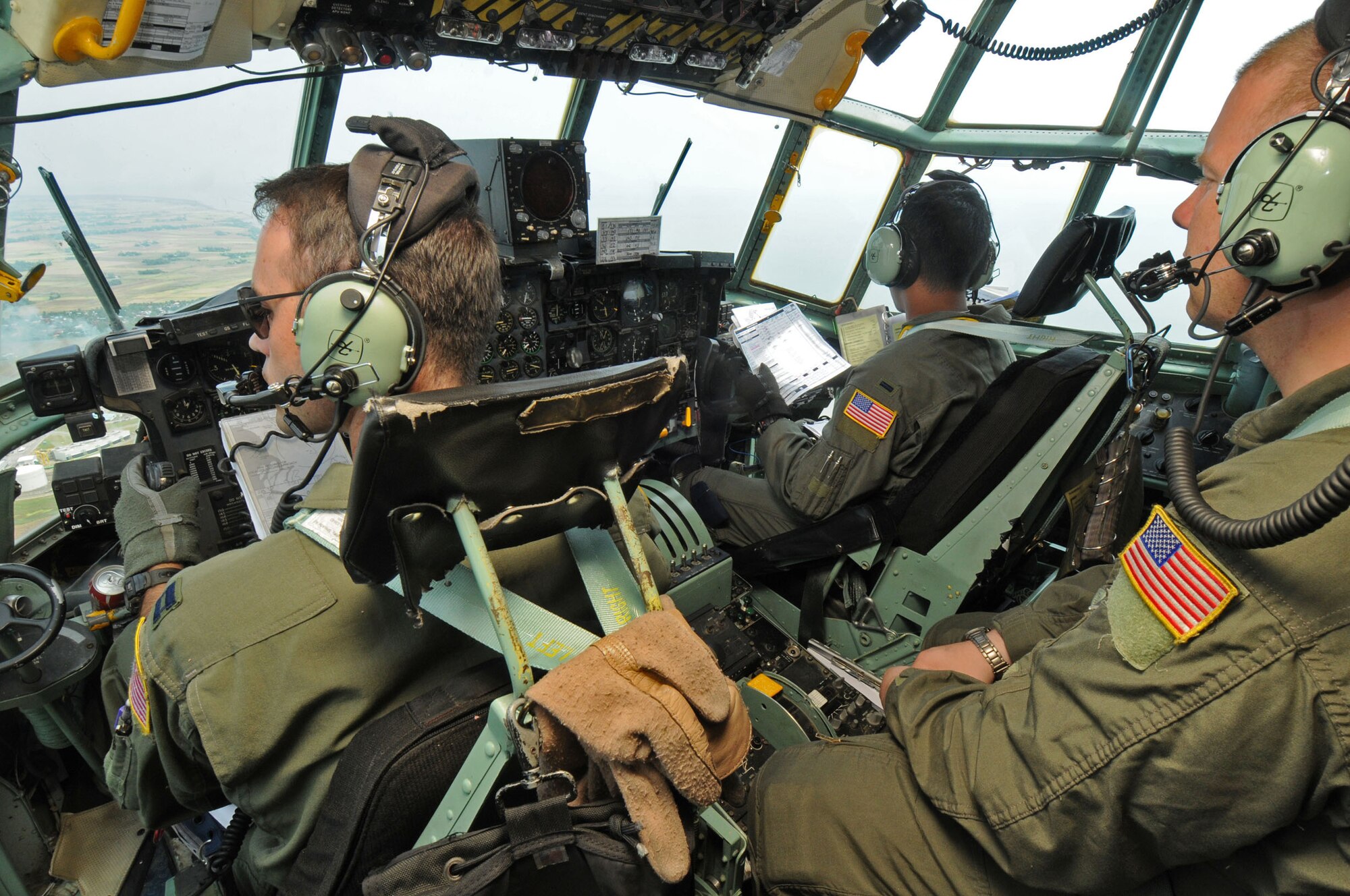 SUBANG ROYAL MALAYSIAN AIR FORCE BASE, Malaysia -- Aircrew members from the 36th Airlift Squadron at Yokota Air Base, Japan, look down on the drop zone from a C-130 Hercules flight deck after airdropping a heavy equipment load Aug. 20 during the 2009 Pacific Airlift Rally here. The PAR is a biennial exercise involving Pacific Rim nations which enhances military airlift interoperability with a focus in humanitarian assistance and disaster relief operations. The exercise consists of a tabletop exercise and a field-training exercise involving three C-130 aircraft from the 374th Airlift Wing at Yokota Air Base, Japan, and one C-130 each from the Royal Malaysian Air Force, Royal Australian Air Force, Republic of Singapore Air Force and Royal New Zealand Air Force. (U.S. Air Force photo/Staff Sgt. Veronica Pierce)