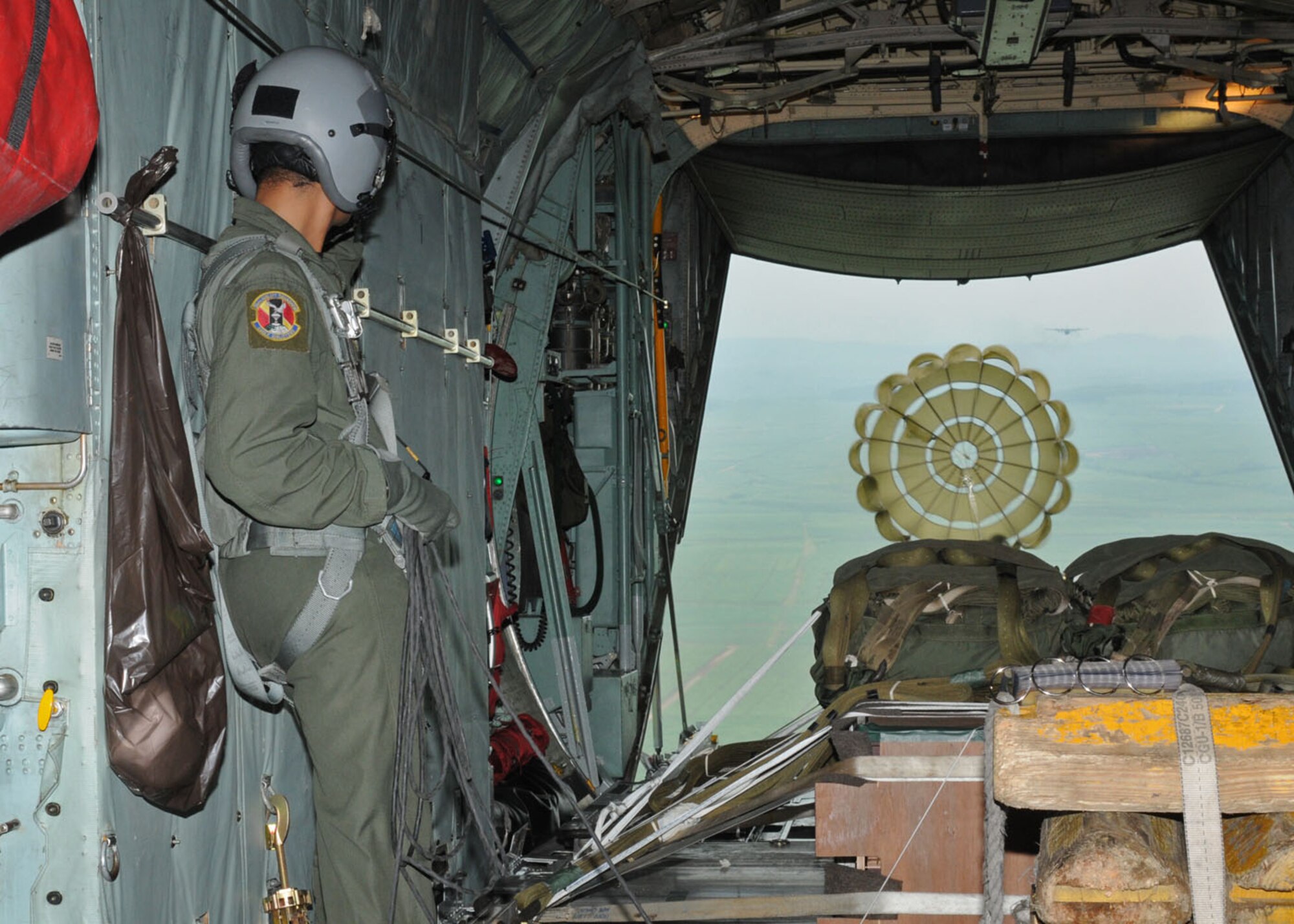 SUBANG ROYAL MALAYSIAN AIR FORCE BASE, Malaysia -- Airman 1st Class Joseph Mitchell-Breakstone, 36th Airlift Squadron loadmaster from Yokota Air Base, Japan, watches as cargo heads toward the drop zone Aug. 20 during the 2009 Pacific Airlift Rally. The PAR is a biennial exercise involving Pacific Rim nations which enhances military airlift interoperability with a focus in humanitarian assistance and disaster relief operations. The exercise consists of a tabletop exercise and a field-training exercise involving three C-130 aircraft from the 374th Airlift Wing at Yokota Air Base, Japan, and one C-130 each from the Royal Malaysian Air Force, Royal Australian Air Force, Republic of Singapore Air Force and Royal New Zealand Air Force. (U.S. Air Force photo/Staff Sgt. Veronica Pierce)