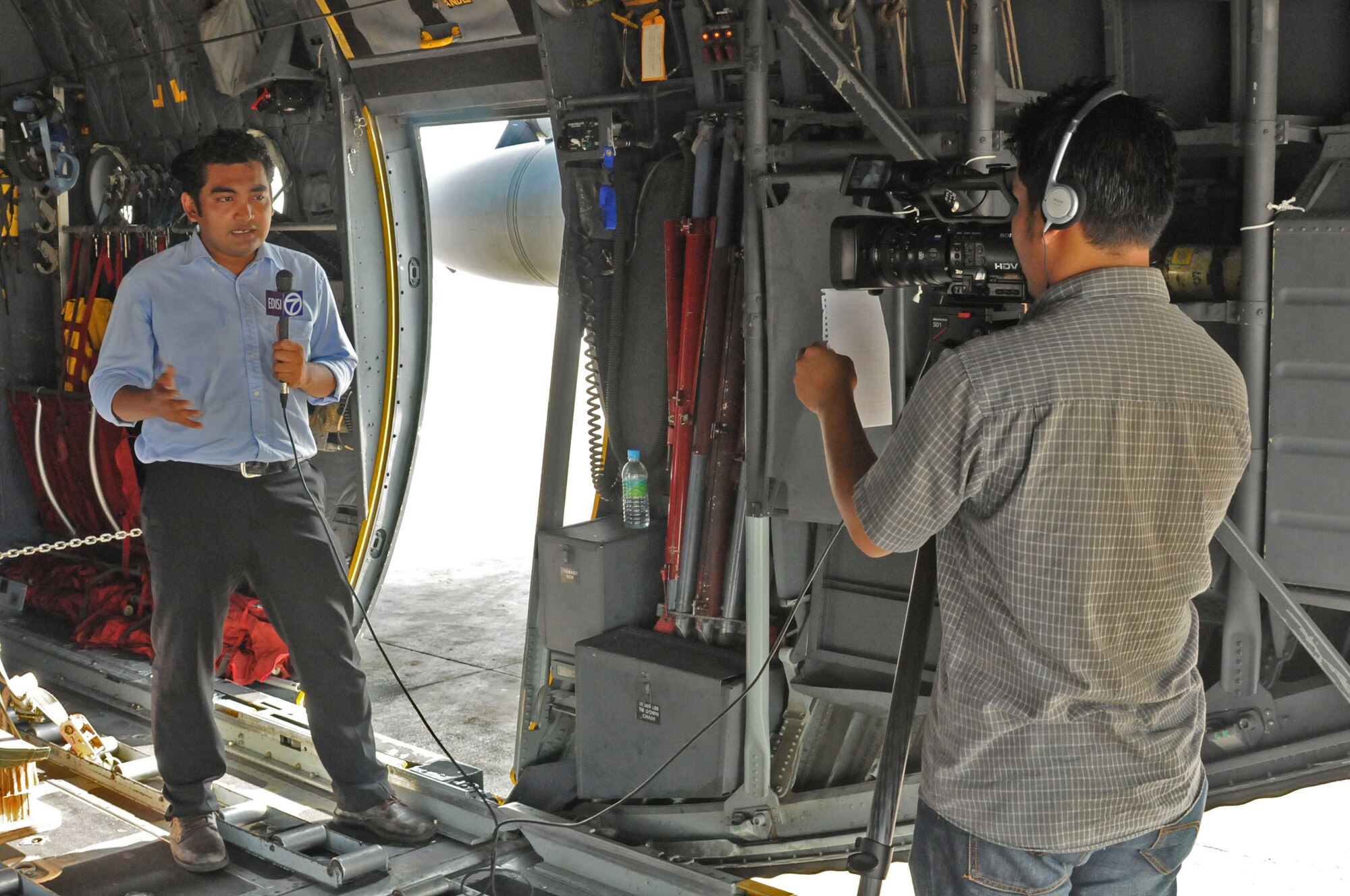 SUBANG ROYAL MALAYSIAN AIR FORCE BASE, Malaysia -- A local news team from Channel 7 in Kuala Lumpur, Malaysia, film aboard a C-130 Hercules from the 36th Airlift Squadron at Yokota Air Base, Japan, Aug. 19 during the 2009 Pacific Airlift Rally. The PAR is a biennial exercise involving Pacific Rim nations which enhances military airlift interoperability with a focus in humanitarian assistance and disaster relief operations. The exercise consists of a tabletop exercise and a field-training exercise involving three C-130 aircraft from the 374th Airlift Wing at Yokota Air Base, Japan, and one C-130 each from the Royal Malaysian Air Force, Royal Australian Air Force, Republic of Singapore Air Force and Royal New Zealand Air Force. (U.S. Air Force photo/Staff Sgt. Veronica Pierce)