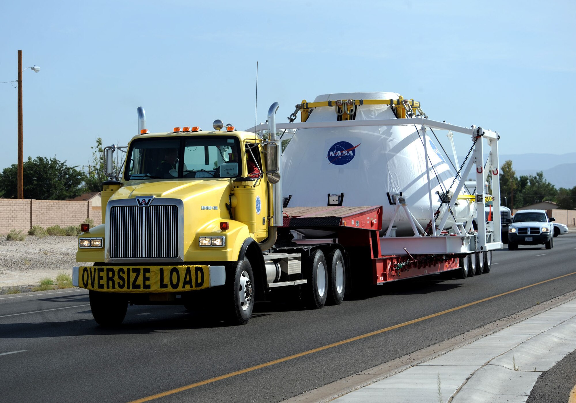 HOLLOMAN AIR FORCE BASE, N.M. -- NASA's next generation of a manned-spacecraft leaves here Aug. 21 enroute to White Sands Missile Range. The module was escorted on base by 49th Security Forces Squadron Airmen and off base by officers from the New Mexico State Police and the New Mexico Department of Public Safety Motor Transportation Division along with deputies from the Otero County Sheriff's Department. (U.S. Air Force by Senior Airman Michael Means) 