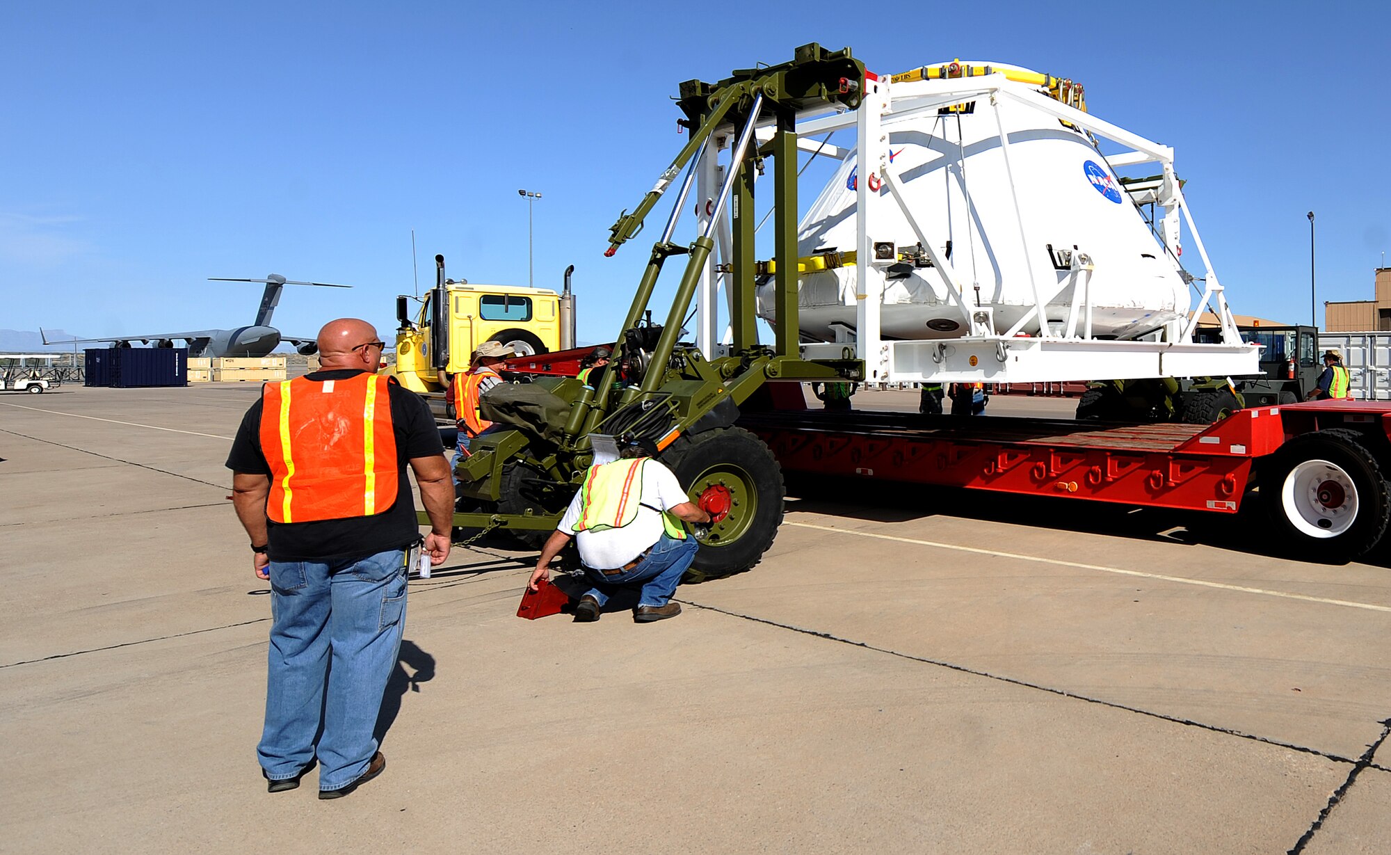 HOLLOMAN AIR FORCE BASE, N.M. -- Crews work to place the Pad Abort One Crew Module on a tractor-trailer here Aug. 20 at BEAR Base before was transported to White Sands Missile Range Aug. 21. The module is part of the Orion Program which will take the next generation of astronauts to space when the shuttle is replaced. (U.S. Air Force by Senior Airman Michael Means) 
