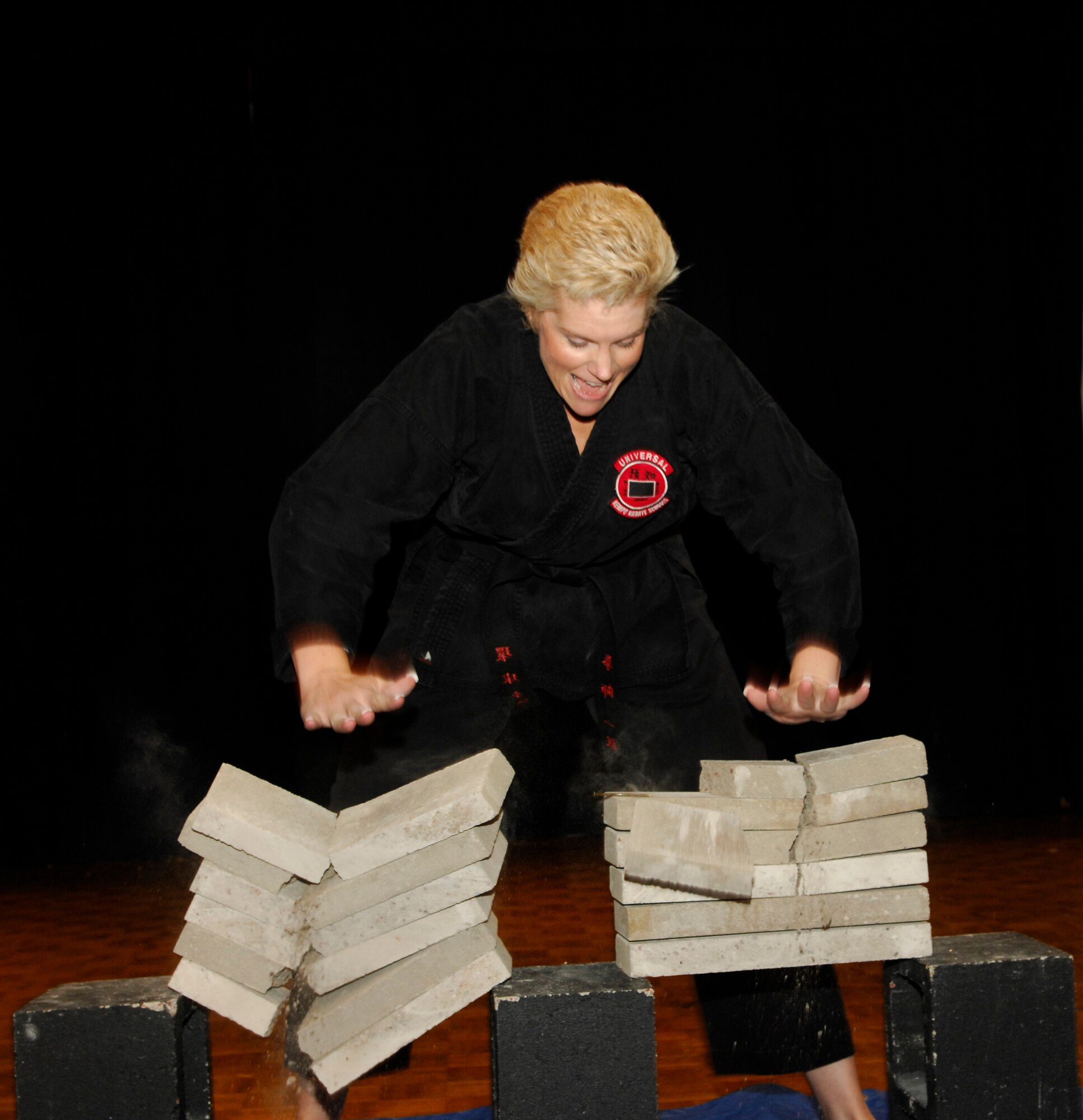 VANDENBERG AIR FORCE BASE, Calif. -- Using Chinese Kempo Karate methods, Debbie Drap of Universal Kempo Karate breaks a stack of bricks during Cultural Heritage Day here Aug. 20. Universal Kempo Karate, a school of Chinese martial arts, has a branch located at Vandenberg with more than 120 students. (U.S. Air Force photo/Airman 1st Class Heather R. Shaw)