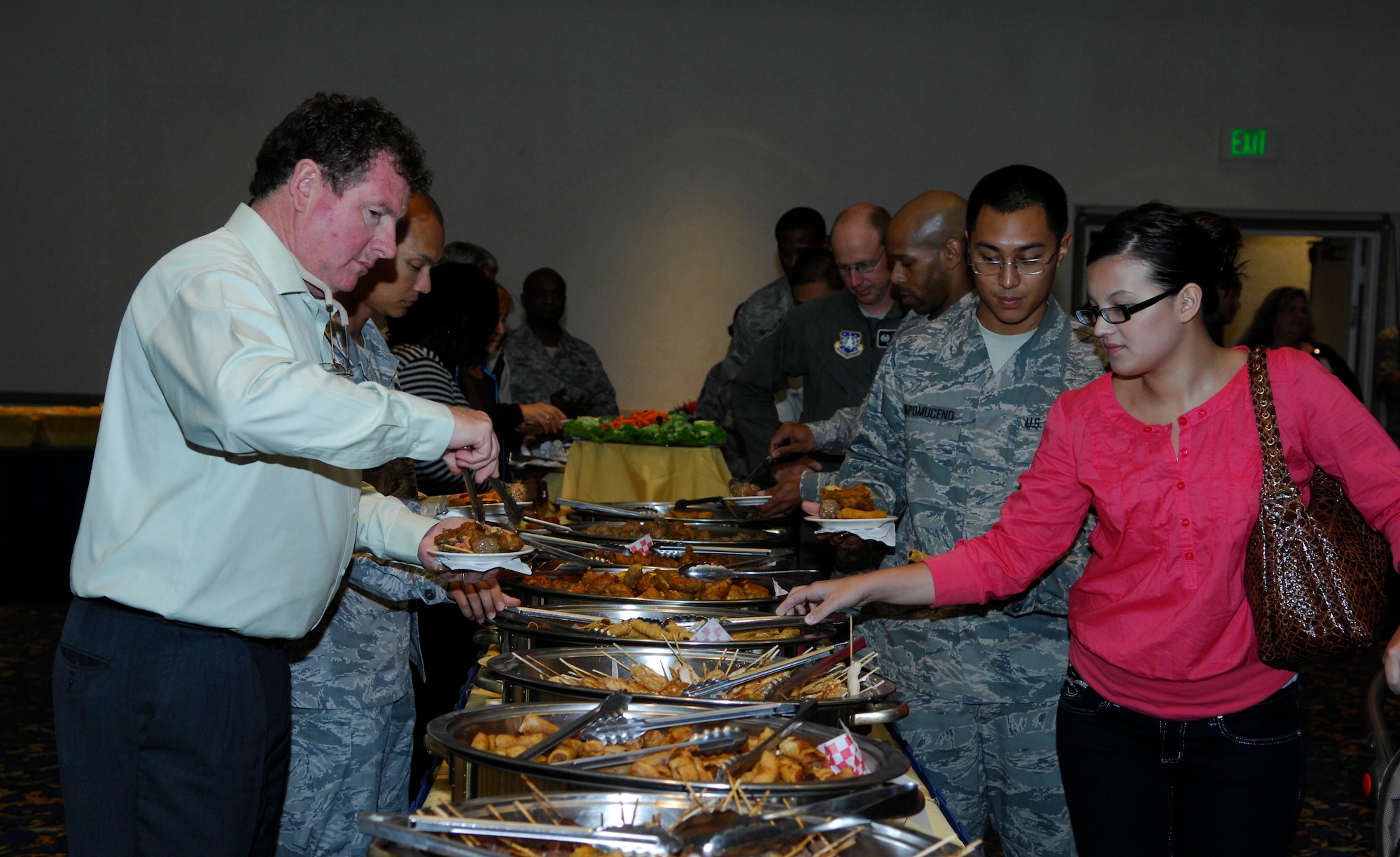 VANDENBERG AIR FORCE BASE, Calif. -- Taking advantage of the opportunity to try foods that they might not eat otherwise, Team V members venture through the buffet line of foods from different areas of the world during Cultural Heritage Day here Aug 20. The event, sponsored by the Vandenberg Equal Opportunity Office, highlighted the diversity of the Air Force. (U.S. Air Force photo/Airman 1st Class Heather R. Shaw)