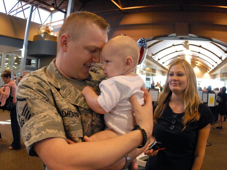 Master Sgt. Erik Clemenson, of the 119th Security Forces Squadron, holds his son for the first time upon his return to Hector International Airport, Fargo, N.D., Aug. 18, after a six-month deployment to Iraq. Clemenson's son was born during his deployment to Kirkuk Air Base beginning in February 2009.  Among his responsibilities was the protection of base personnel and resources by providing security and law enforcement at the base. He and his unit members were tasked with searching local personnel and vehicles, maintaining perimeter security and conducting police services on the base.  (DoD photo by Senior Master Sgt. David H. Lipp)