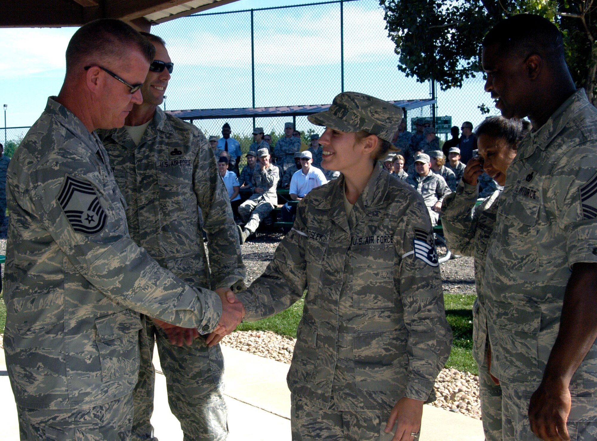 Senior Airman Tonya Woosley, DPS, is congratulated by the Team Buckley Chief's Group, during the staff sergeant selection celebration at Buckley AFB on Aug. 20. Also selected for staff sergeant from ARPC were: Senior Airmen Eric Thayer, DPS; Jason Mendoza and Anawati Jaggernath, DPB; and Joshua Hinton, SC. (U.S. Air Force photo/Mike Molina) 
                                
