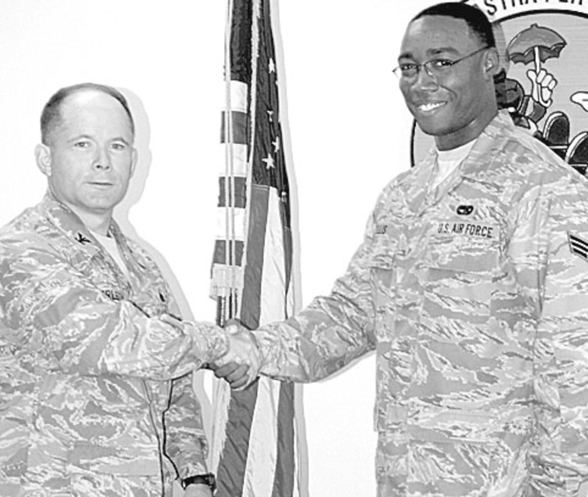 Col. Craig Berlette, 43rd Airlift Wing Vice Commander, presents Senior Airman Marvin Ellis, 3rd Aerial Port Squadron, a Commander’s Coin on behalf of Col. James Johnson, 43rd Airlift Wing Commander, Aug. 18. (U.S. Photo by 2nd Lt. Cammie Quinn)