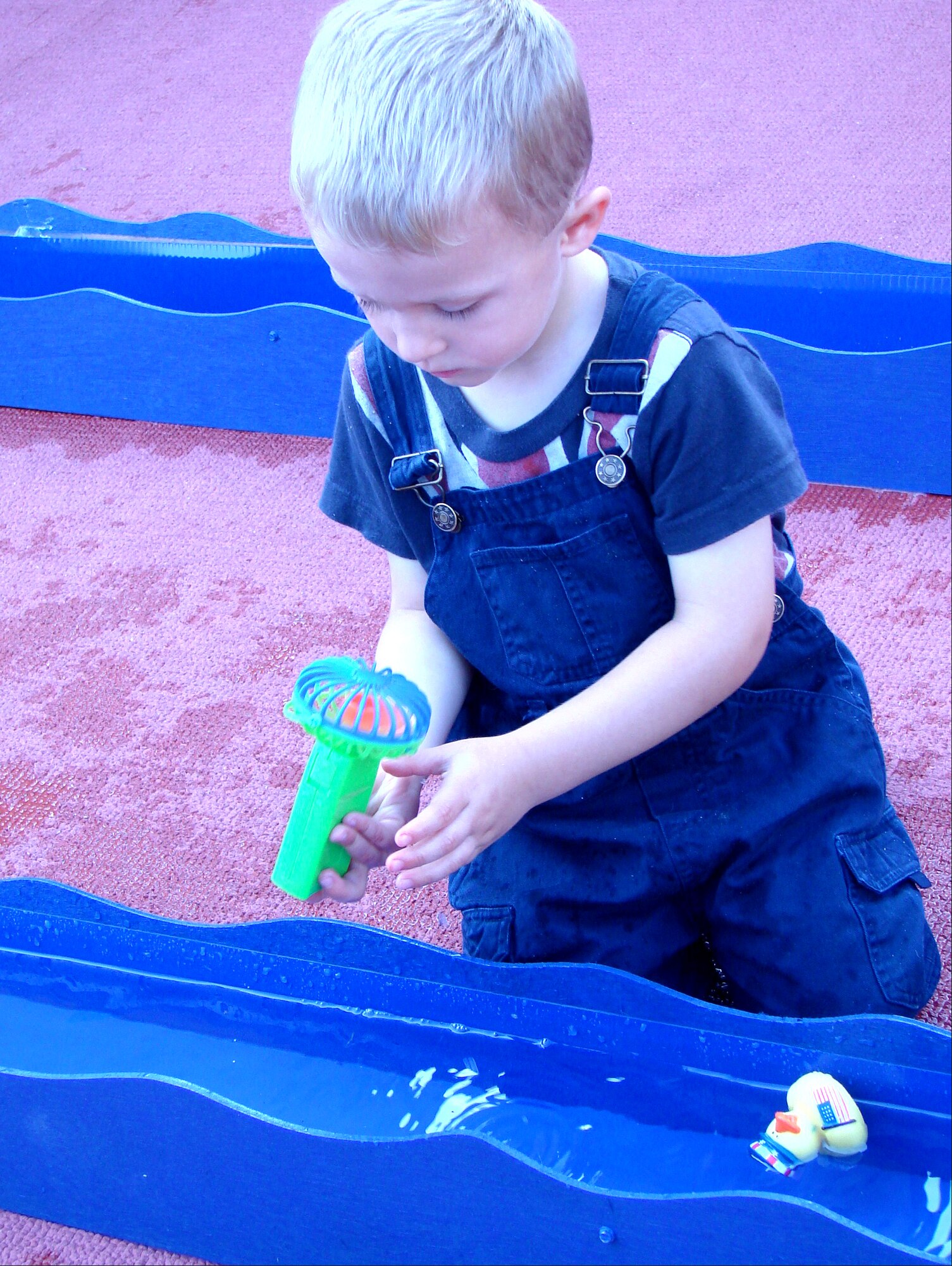 Family member Anthony Vanzo inspects the fan he will use to propel a rubber duck along a trough of water to win a duck race at the Energy Conservation Celebration Aug. 20 at the base fitness center. The party celebrated the end of the Air Education and Training Command Energy Management Incentive Award program, which lasted from July 2008 to June 2009. The program measured the energy usage of 12 Air Force bases, including Vance. The base that saves the highest percentage of energy will earn $1.5 million. There were games, food and music. (U.S. Air Force photo/ Danielle Lutes)