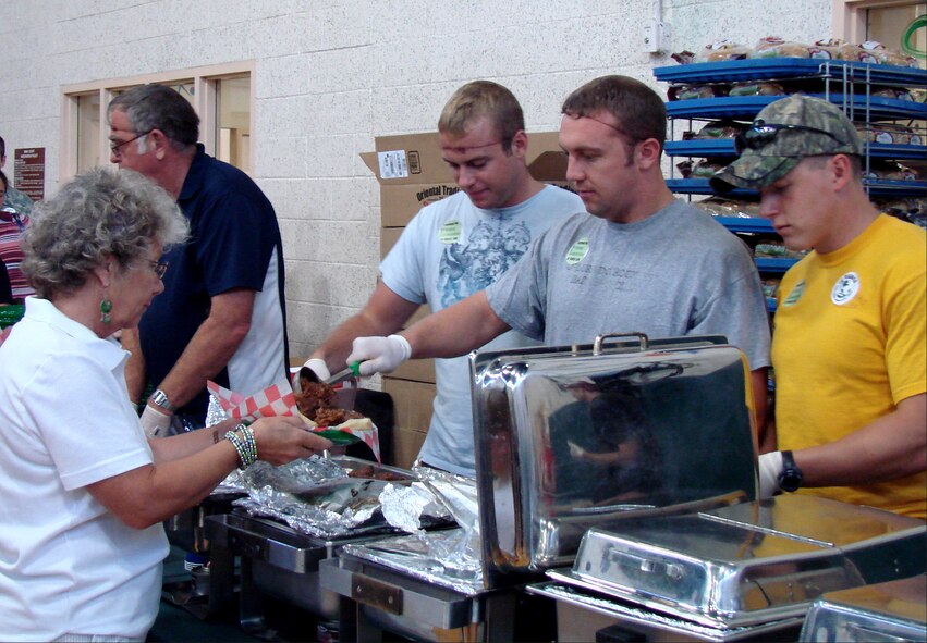 Volunteers serve lunch at the Energy Conservation Celebration on Aug. 19 at the fitness center on base. The party celebrated the end of the Air Education and Training Command Energy Management Incentive Award program, which lasted from July 2008 to June 2009. There were games, free food and music. (U.S. Air Force photo/ Danielle Lutes) 