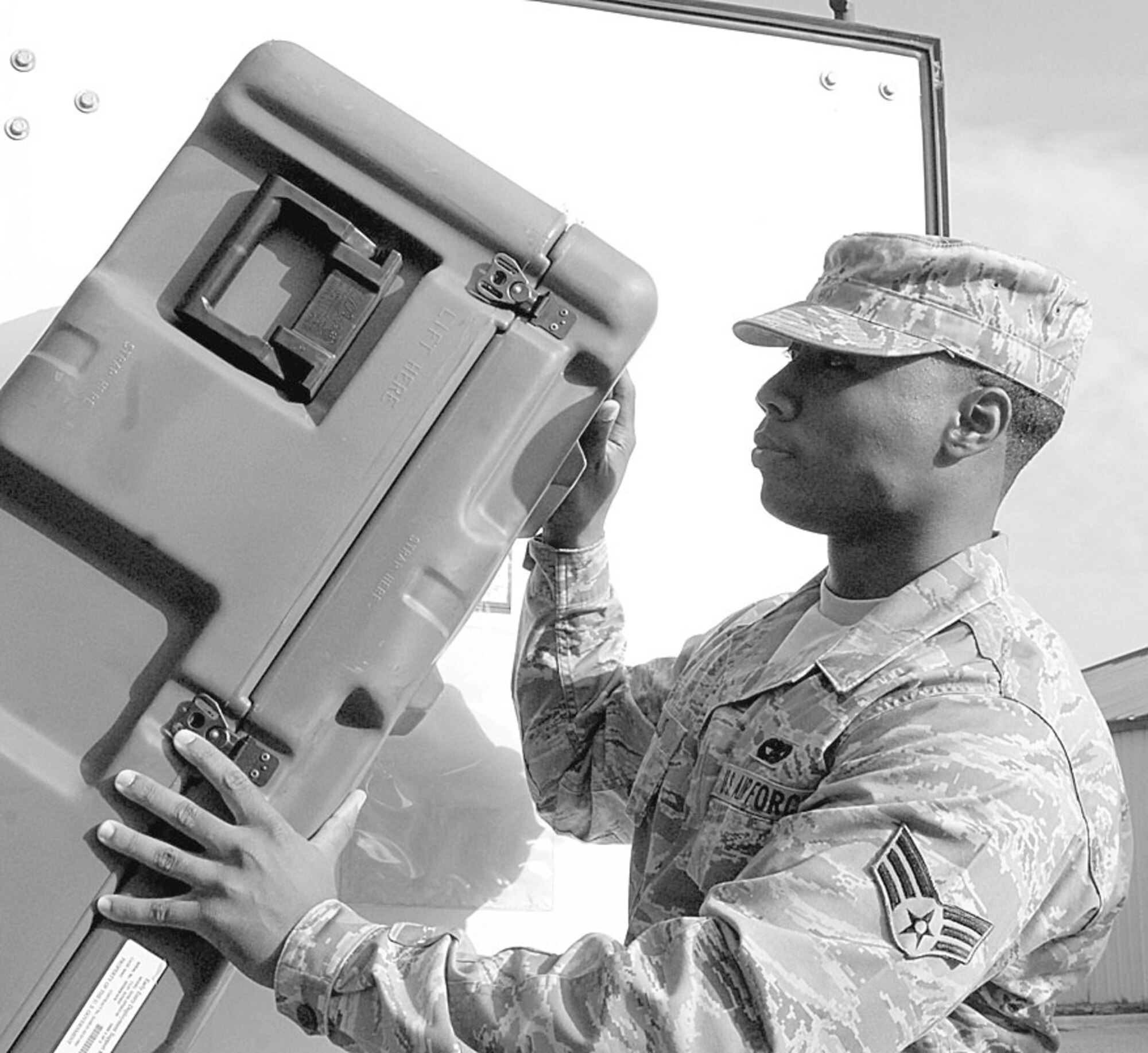 Senior Airman Marvin Ellis, 3rd Aerial Port Squadron, stows away a UTC package as part of his job duties as a Combat Readiness Technician. (U.S. Photo by 2nd Lt. Cammie Quinn)