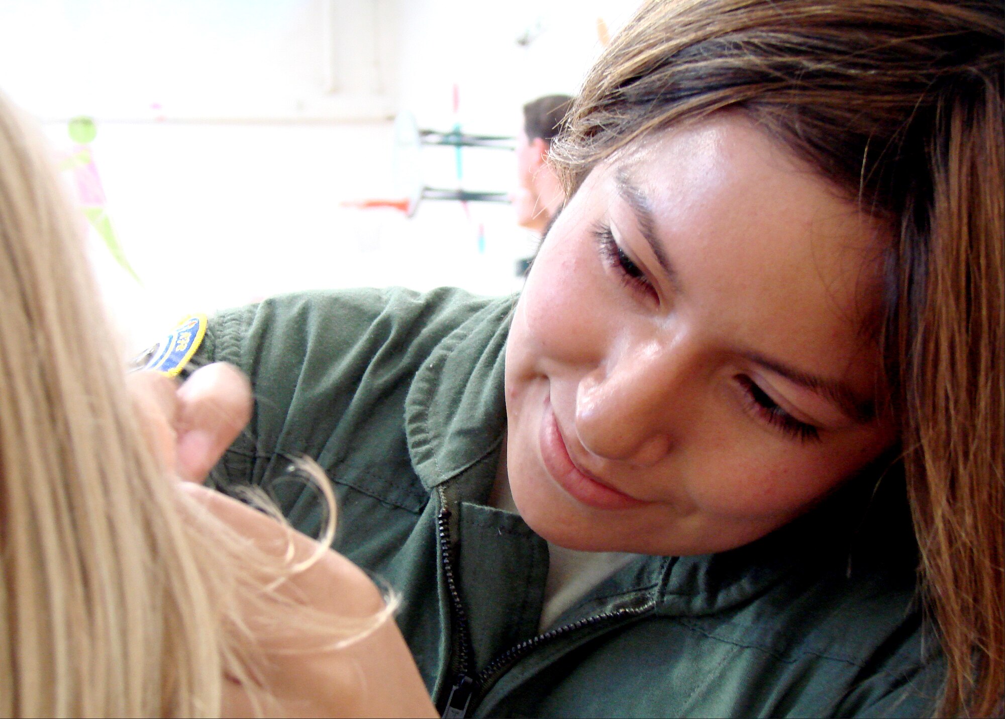 Airman 1st Class Christina Valentin, with the 71st Medical Operations Squadron, paints a butterfly on the cheek of Ashley Callaghan at the Energy Conservation Celebration Aug. 20 at the fitness center on Vance AFB. The party celebrated the end of the Air Education and Training Command Energy Management Incentive Award program, which lasted from July 2008 to June 2009. There were games, food and music. (U.S. Air Force photo/ Danielle Lutes)