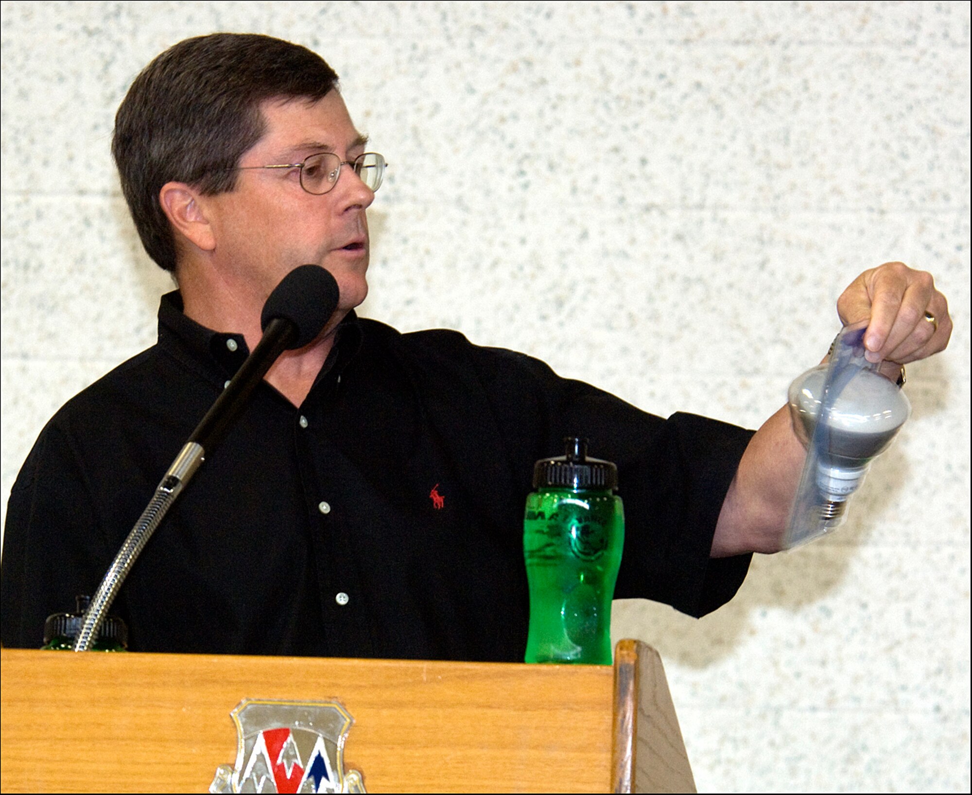 Jeff Hume, the chief operating officer of Continental Resources in Enid, Okla., discusses an energy efficient light bulb with Team Vance during the Energy Conservation Celebration Aug. 20 at the Fitness Center on base. Mr. Hume, the keynote speaker at the celebration, also talked about the three energy Rs: reduce, reuse and recycle. The party celebrated the end of the Air Education and Training Command Energy Management Incentive Award program, which ran from July 2008 to June 2009. There were games, free food and music. (U.S. Air Force photo/ Terry Wasson)