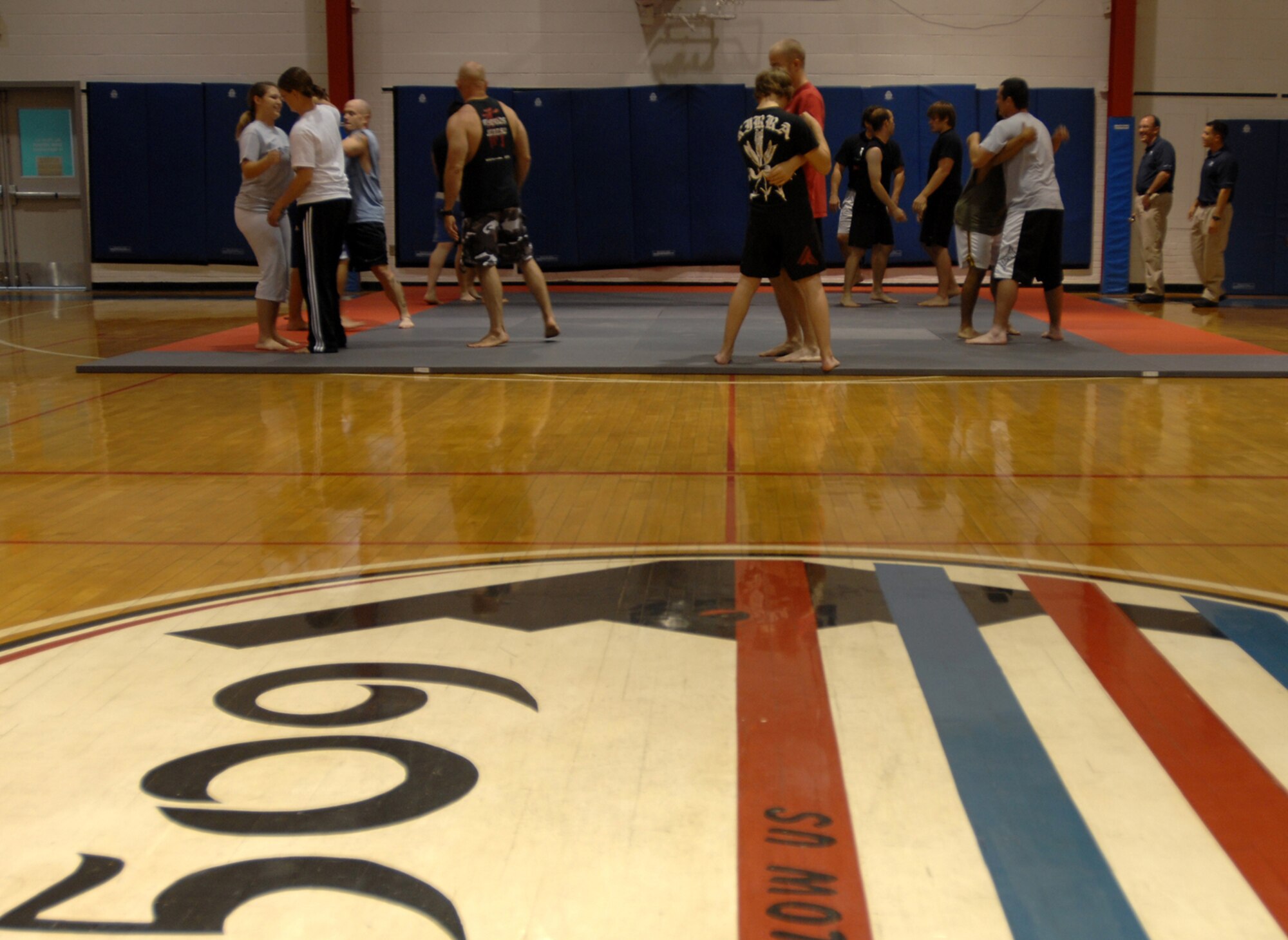 WHITEMAN AIR FORCE BASE, Mo. - Airmen and their families participate in a Mixed Martial Arts training class, Aug. 20. Dan Severn, American mixed martial artist and professional wrestler, gives UFC tips and instruction about ultimate fighting to members of Team Whiteman Aug. 20. Mr. Severn performed three different training sessions for Airmen and their families stationed at Whiteman. (U.S. Air Force photo/Senior Airman Kenny Holston)