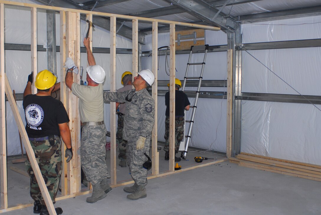 Members of the 149th Civil Engineer Squadron erect an interior wall for an office in the Expeditionary Medical Support (EMEDS) building, on the grounds of the Military Central Hospital in Yerevan, Armenia. The Texas Air National Guard civil engineers deployed from San Antonio, Texas, to Yerevan to work on security cooperation initiatives and humanitarian assistance projects during the first two weeks of August 2009. The EMEDS building will accommodate medical equipment, supplies, tents and personnel to facilitate Armenian response to natural disasters and wartime contingencies. (Texas Military Forces photo by Tech. Sgt. Rene Castillo)