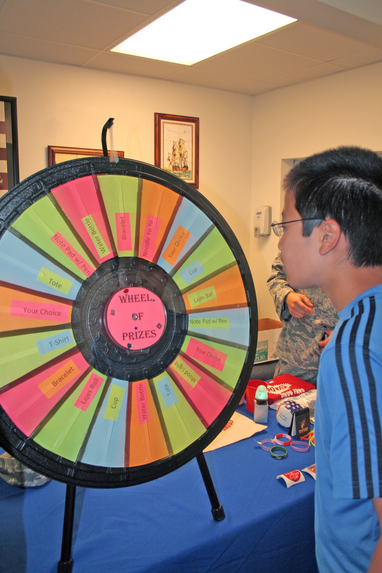 Yohei Sparks watches as the "Wheel of Prizes" spins while he waits to find out what he has won for answering a question about health and wellness correctly at the health fair during the school and sports physical day held Aug. 20 at Lajes Field, the Azores. Yohei is who is the son of Hitomi Sparks, a dependent here. The health fair highlighted dental education, physical fitness tips and health and wellness information. (U.S. Air Force photo/Capt. George Tobias)