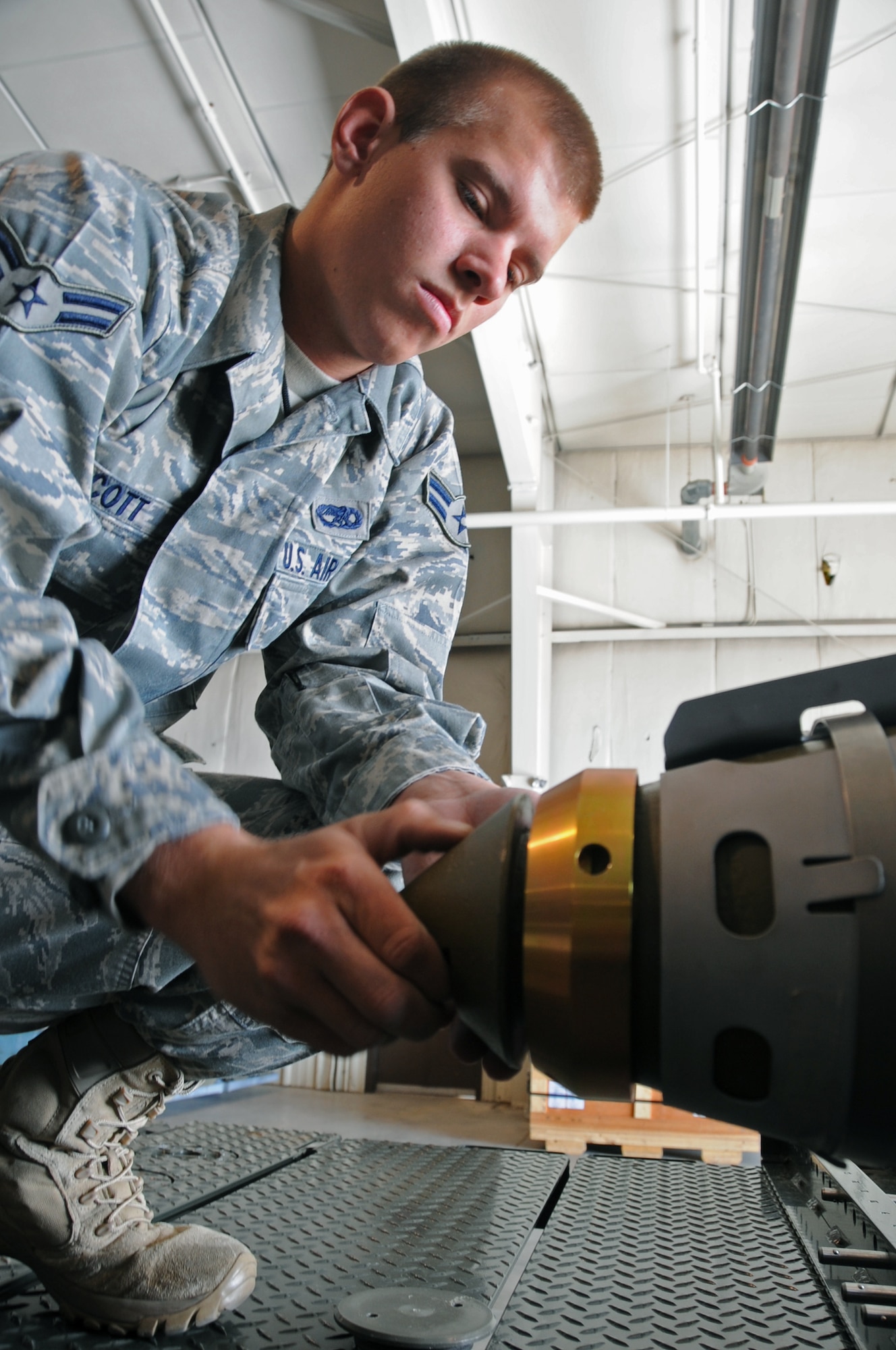 Airman 1st Class Derrick Scott, 28th Munitions Squadron conventional maintenance crew member, pieces together a Guided Bomb Unit-38 here, August 20.  The GBU-38 is a 500-pound bomb which is commonly used in the B-1B Lancer's arsenal. (U.S Air Force photo/Airman 1st Class Anthony Sanchelli)