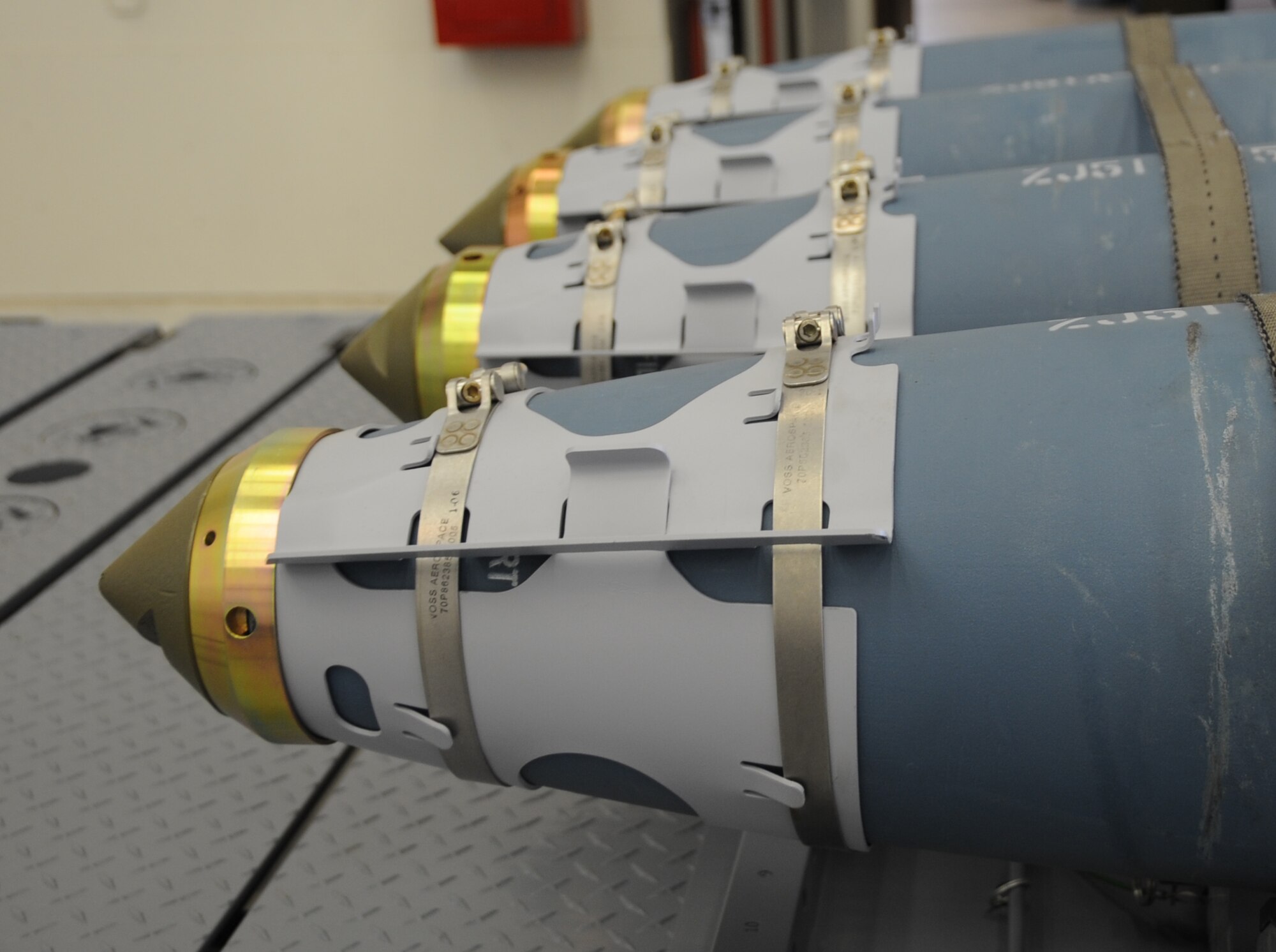 Four Guided Bomb Unit-38's are lined up and strapped down on a Munitions Handling Unit-226, ready for the 28th Munitions Squadron Airmen to train with here, August 20. The GBU-38 is a 500-pound bomb commonly used with the B-1B Lancer. (U.S Air Force photo/Airman 1st Class Anthony Sanchelli)