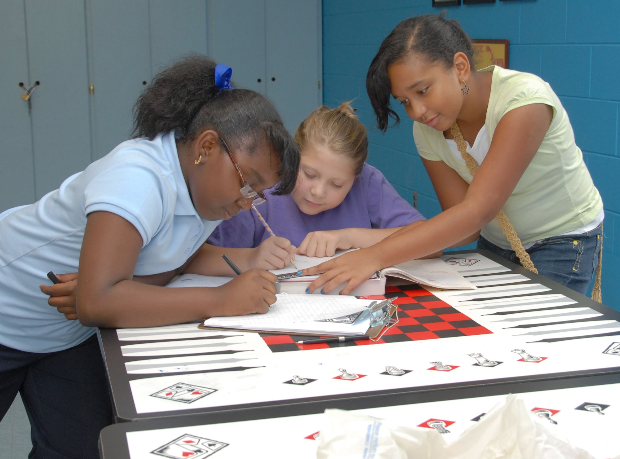 Children in the Gunter Youth Center program study together during Power Hour, the center's homework time. Shown from left are Taylor Gardner, 11, Jocelyn Stout, 12, and Denise Baylor, 11. (U.S. Air Force photo/Roger Curry)