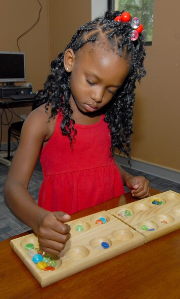 Amaiya Cornelius, 6, plays a board game at the Maxwell School Age Center. The center provides care for children ages five to 12 both before and after school. (U.S. Air Force photo/Jamie Pitcher)